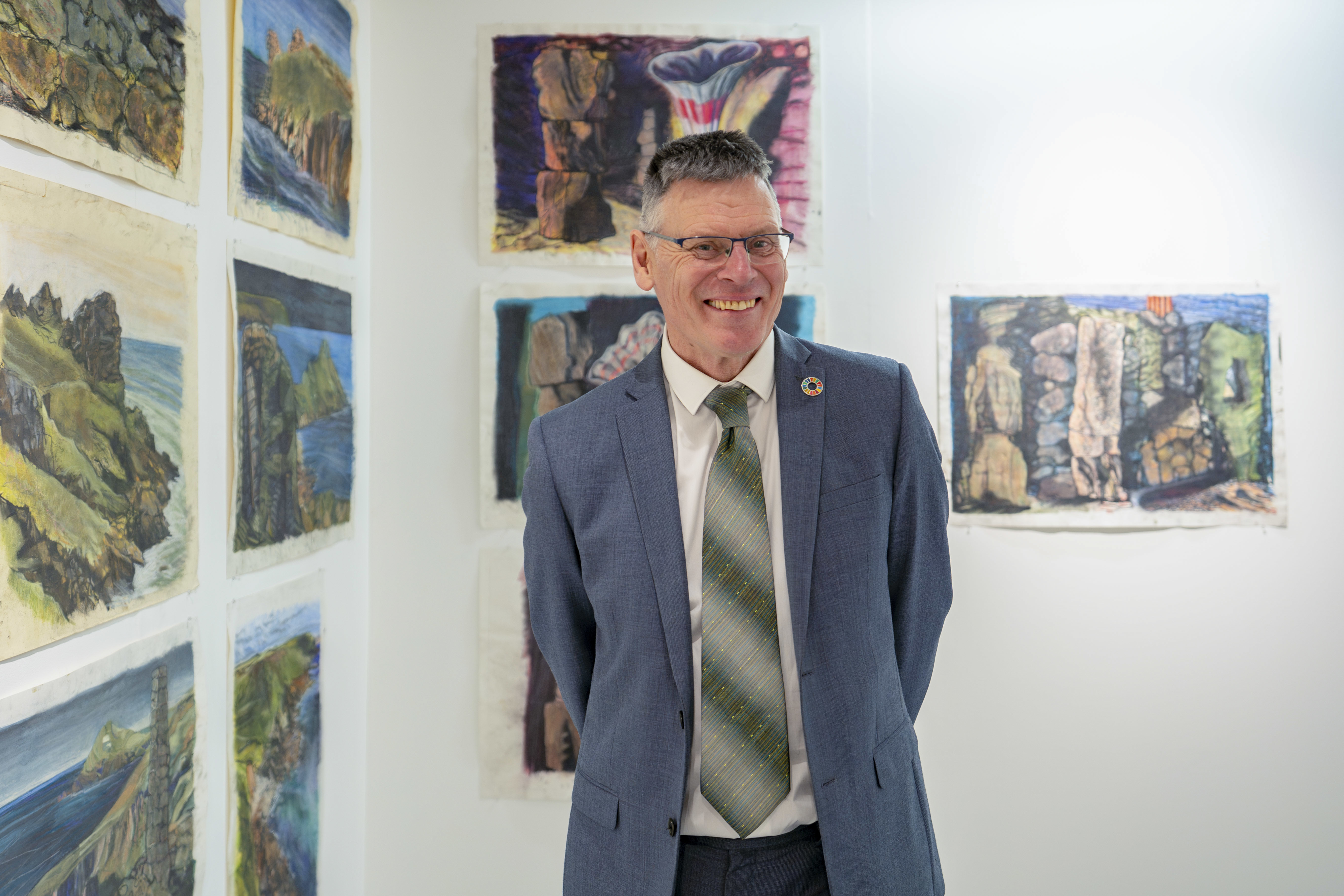 Professor P Gough posing for a photo at "Purbeck, Penwith and Purnululu" exhibition at TheGallery, AUB.