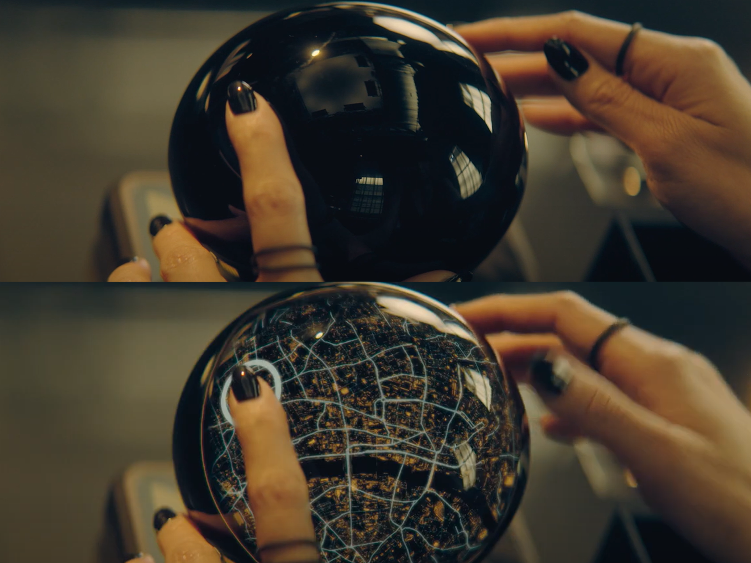 Two stills of a close-up of a pair of hands handling a crystal ball. The top image shows the ball with a dull reflection, the bottom image shows a bird's eye view of a city at night reflected in the ball.