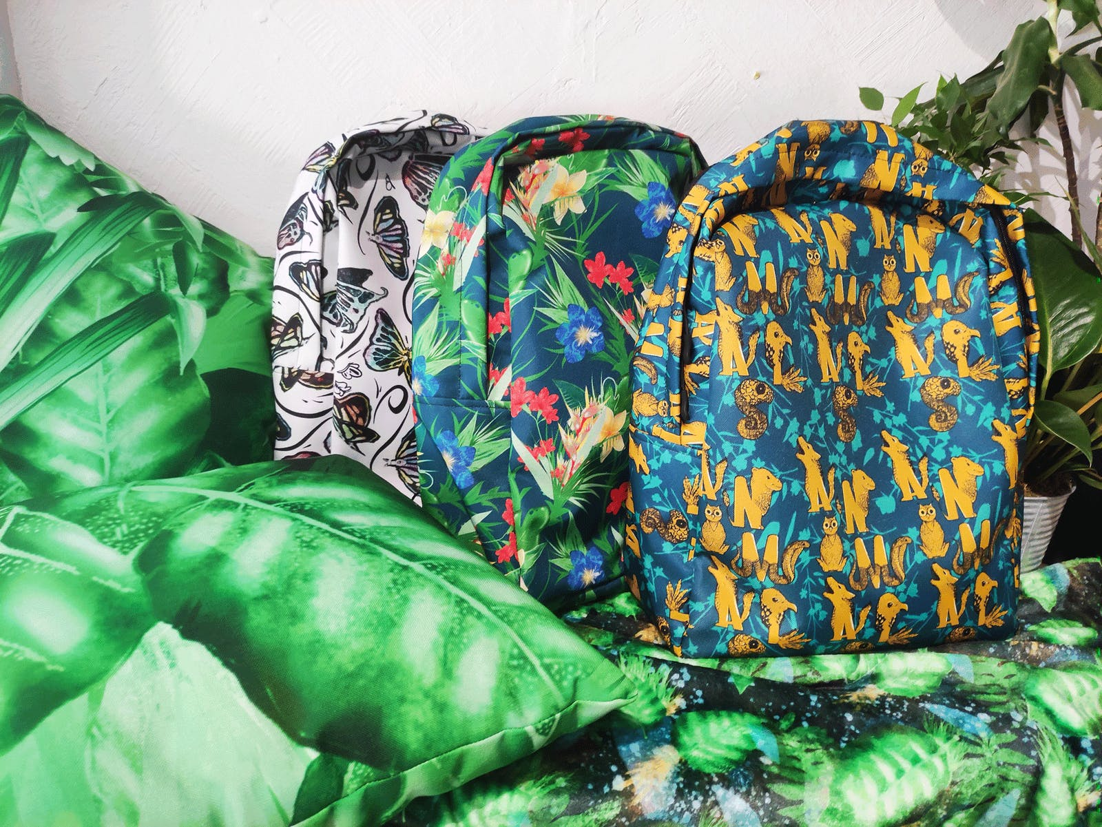 3 backpacks with natural illustration patterns printed on them