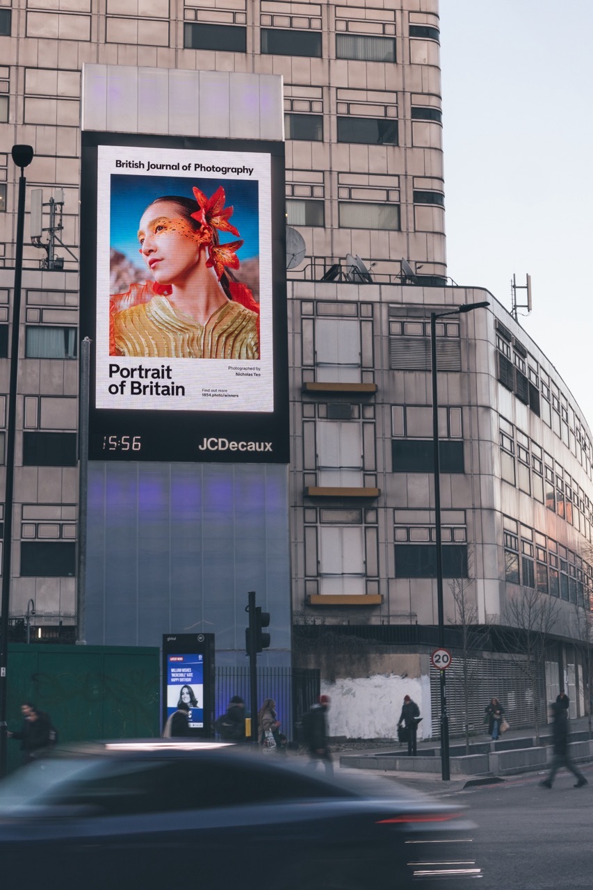 Photography by Nicholas Teo displayed on a billboard in an urban setting.