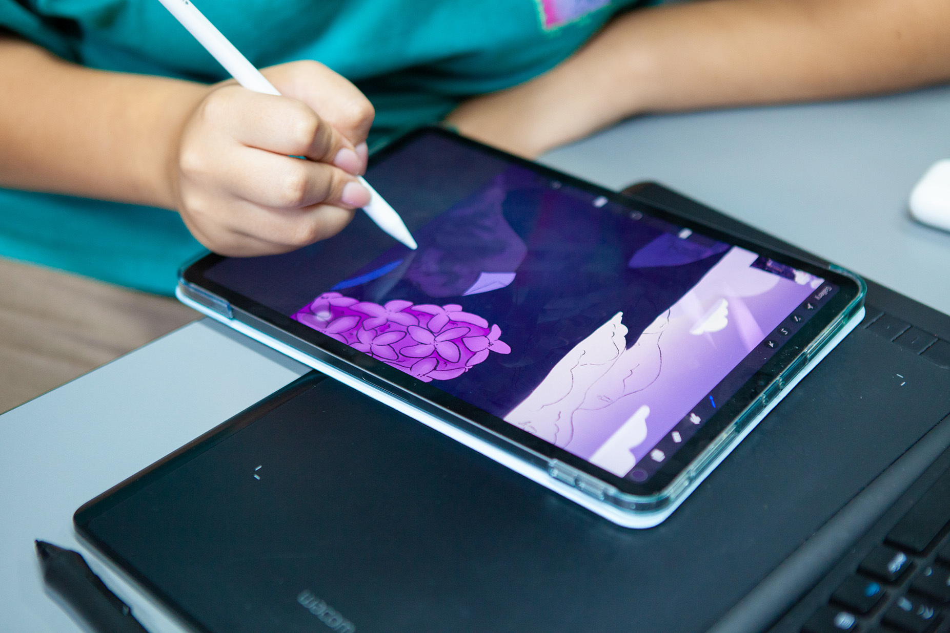 A student using a tablet to draw a colourful design