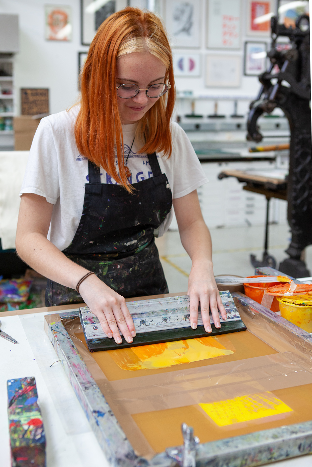 A student is screen printing