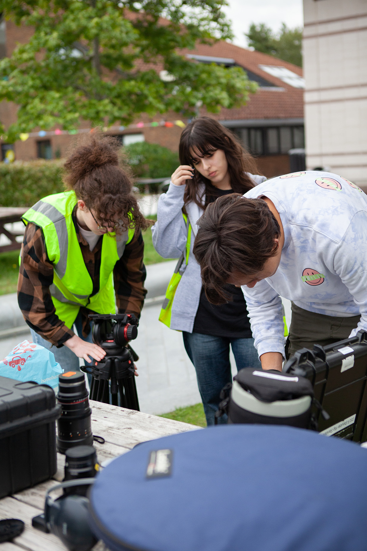 Group of students looking at some film equipment