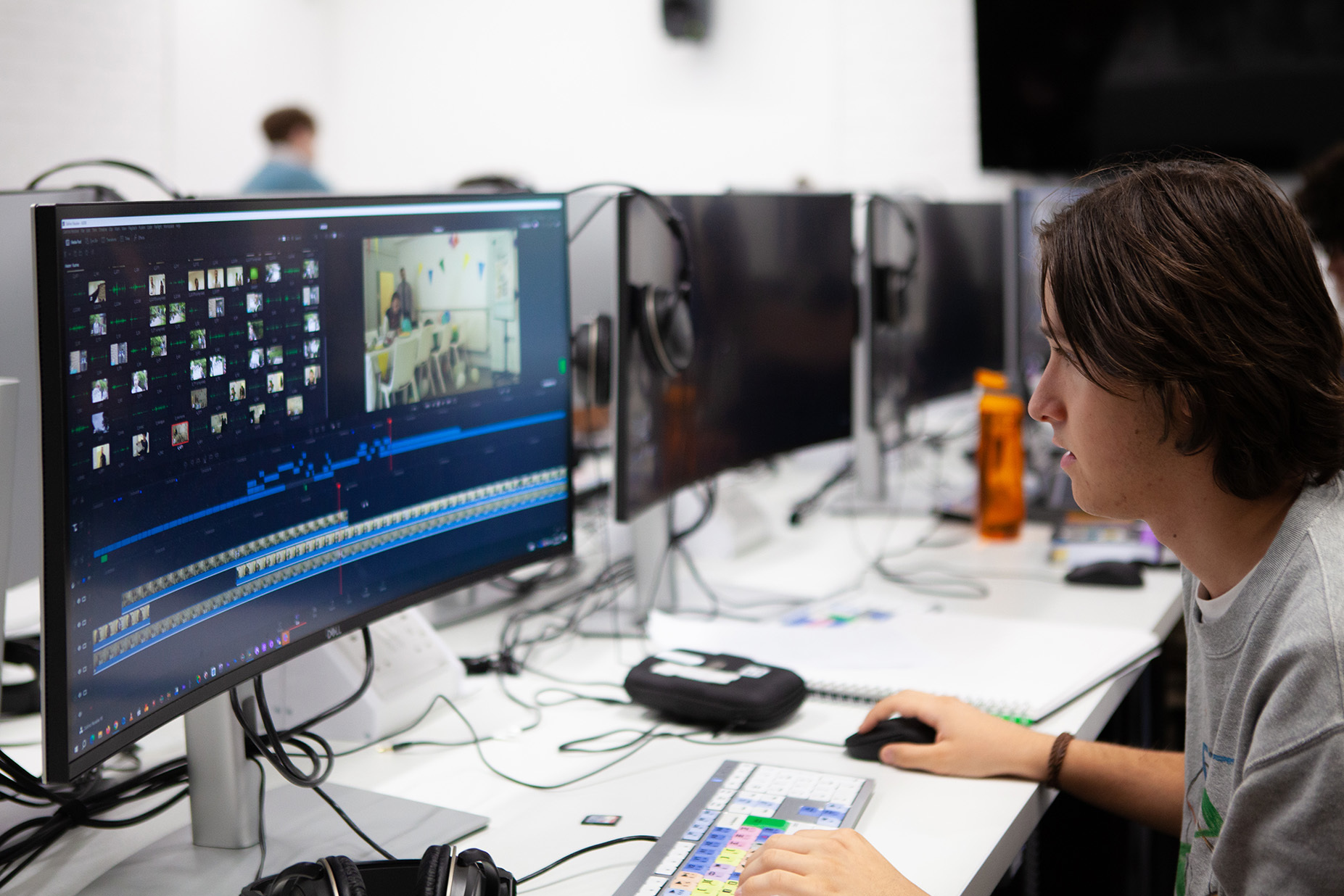 Student editing a film timeline on a computer