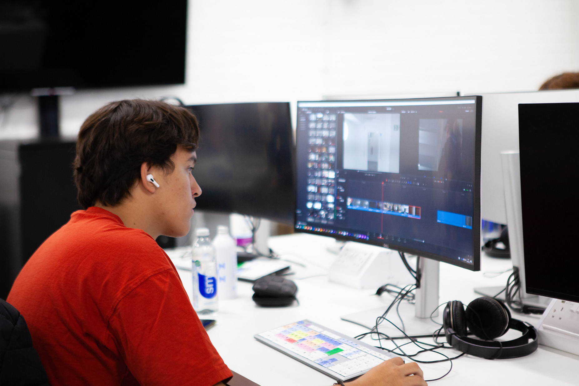 Student editing a film timeline on a computer