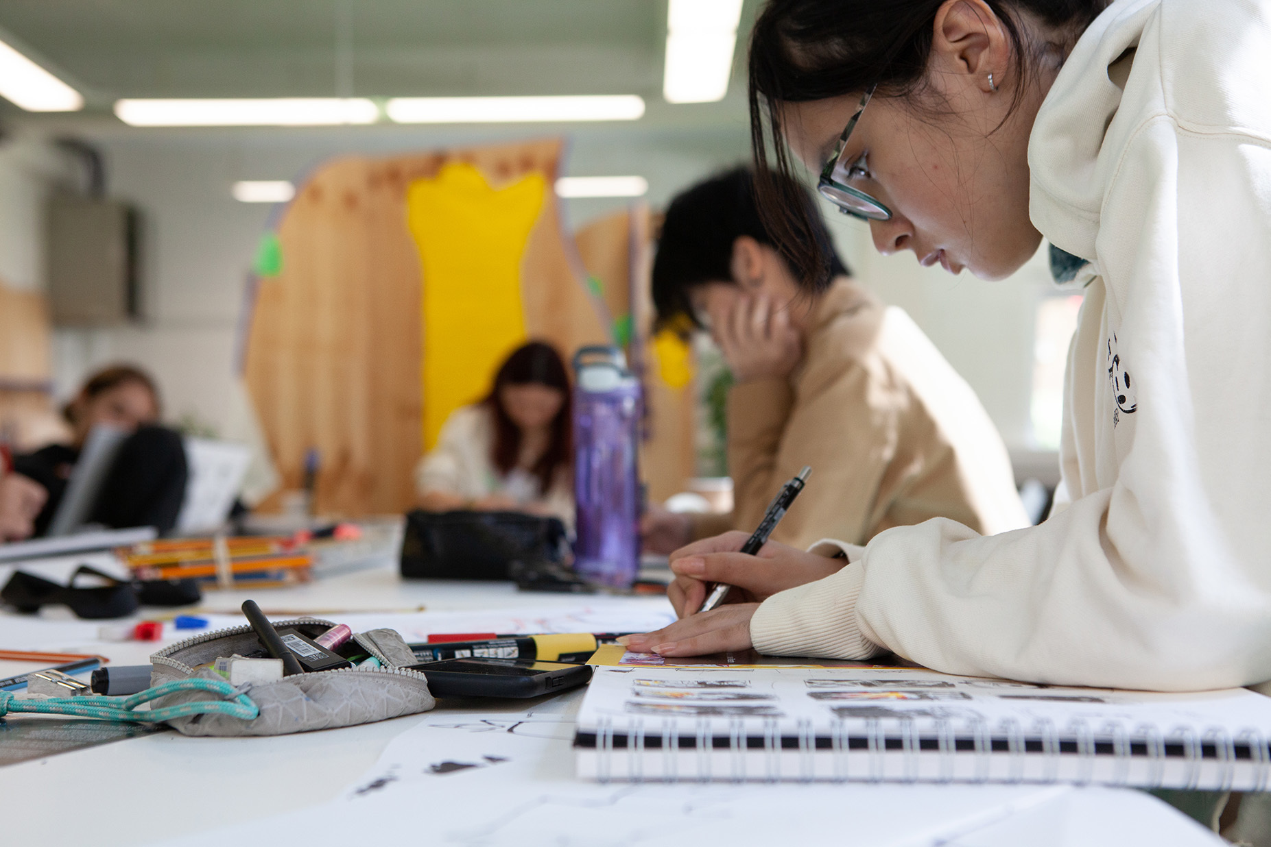 Students drawing in sketchbooks