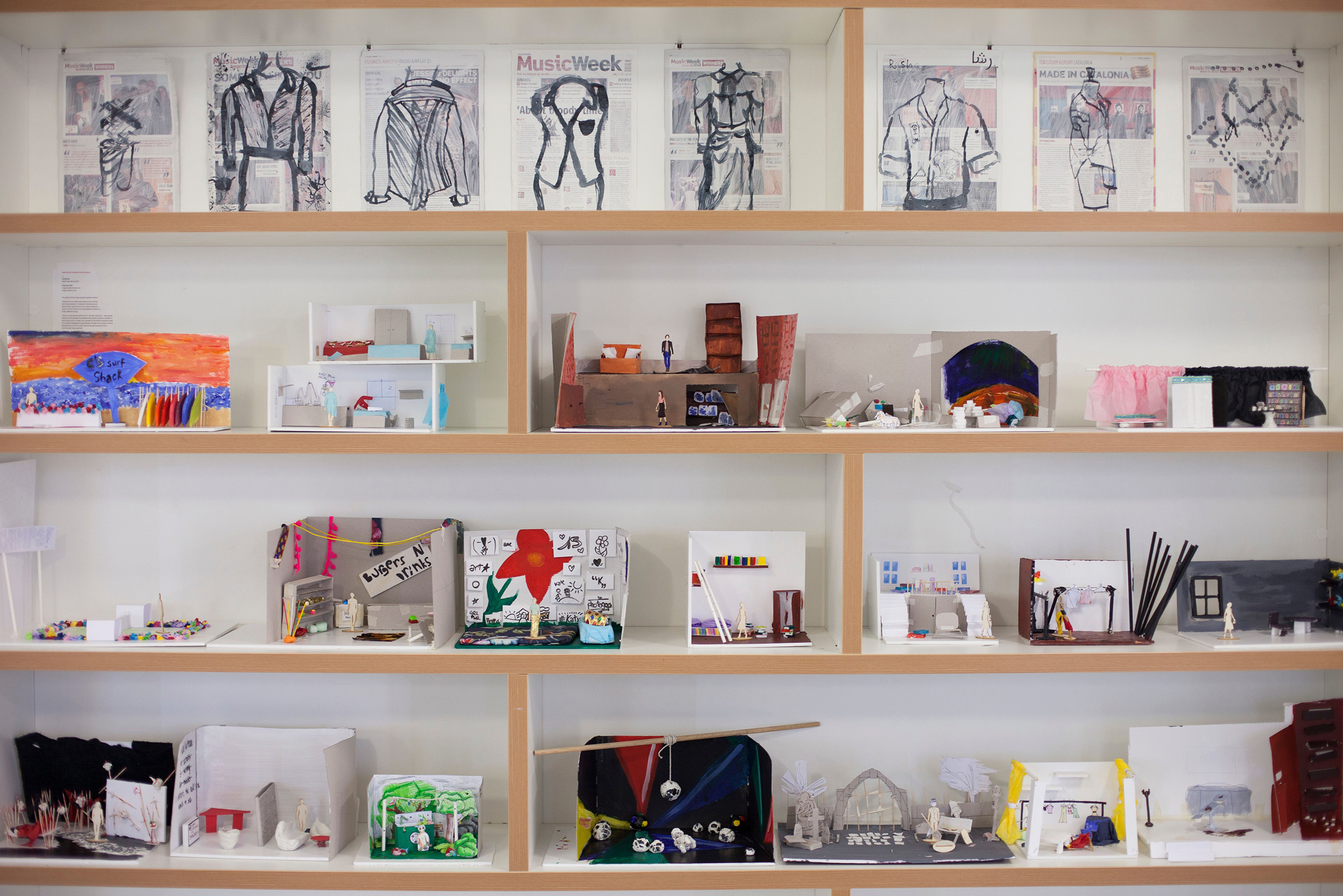shelves containing student work – illustrations and small-scale models