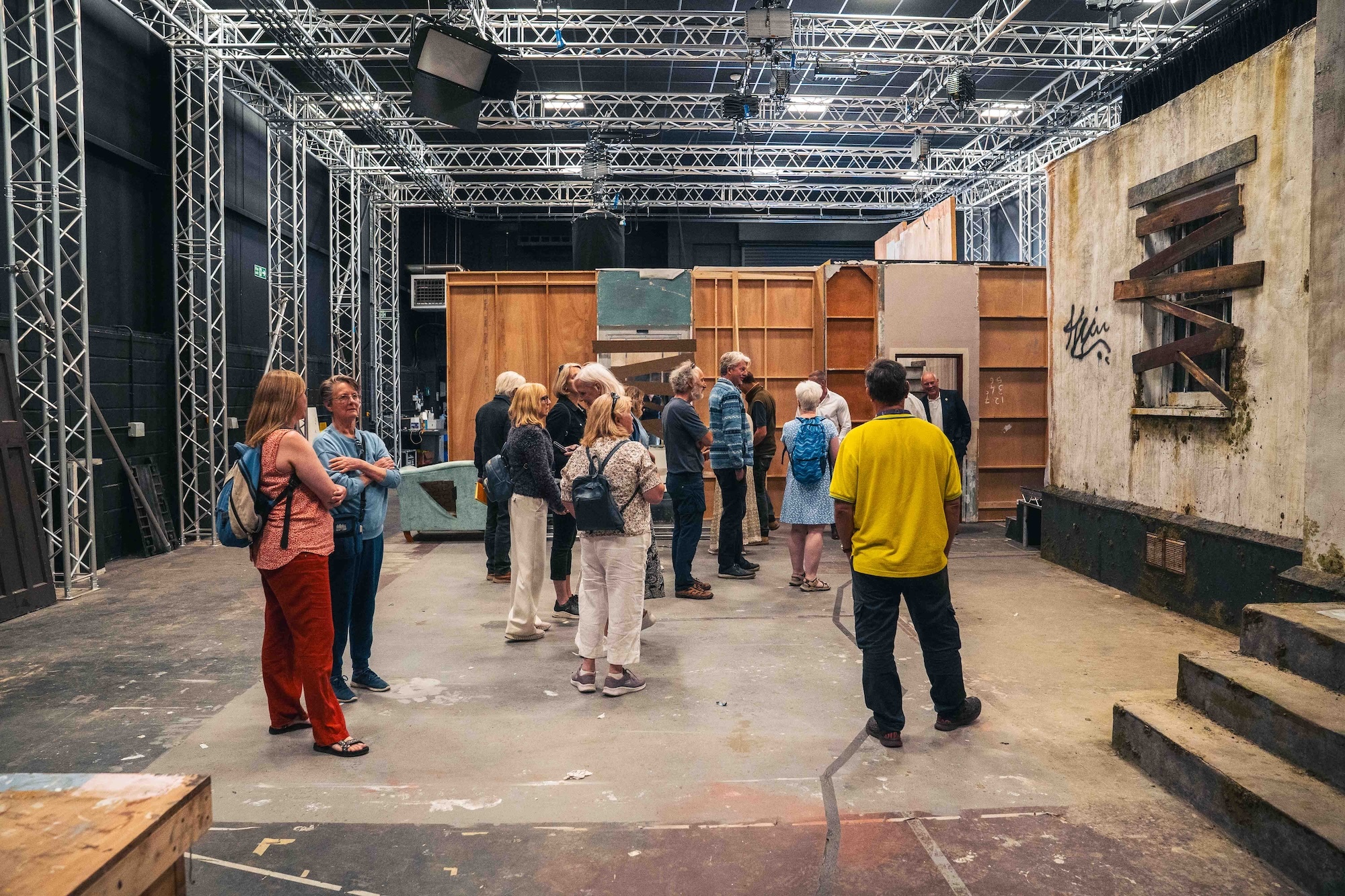 A group of BCP councillors visiting a film set designed as the exterior of a derelict house, at Elliott Road Studios, Arts University Bournemouth.
