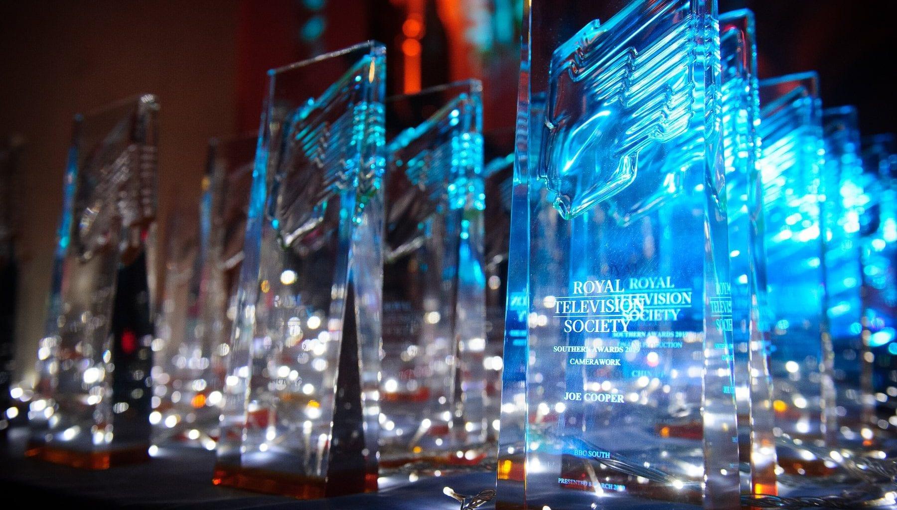 A close-up photo of several glass trophies with the words ROYAL TELEVISION SOCIETY on them