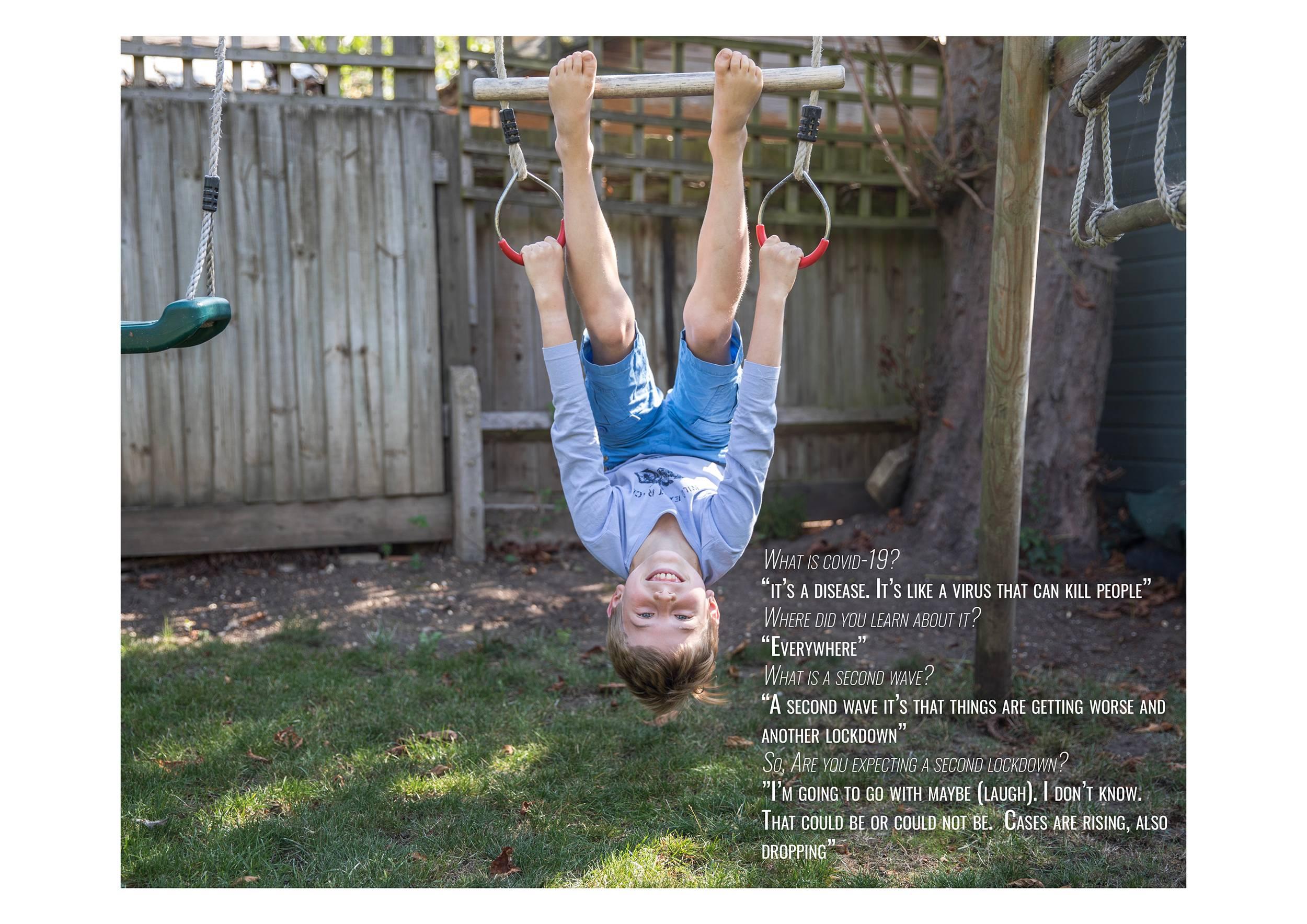 Child hanging upside-down from gym hoops in a garden. A block of text appears in the bottom-right corner.