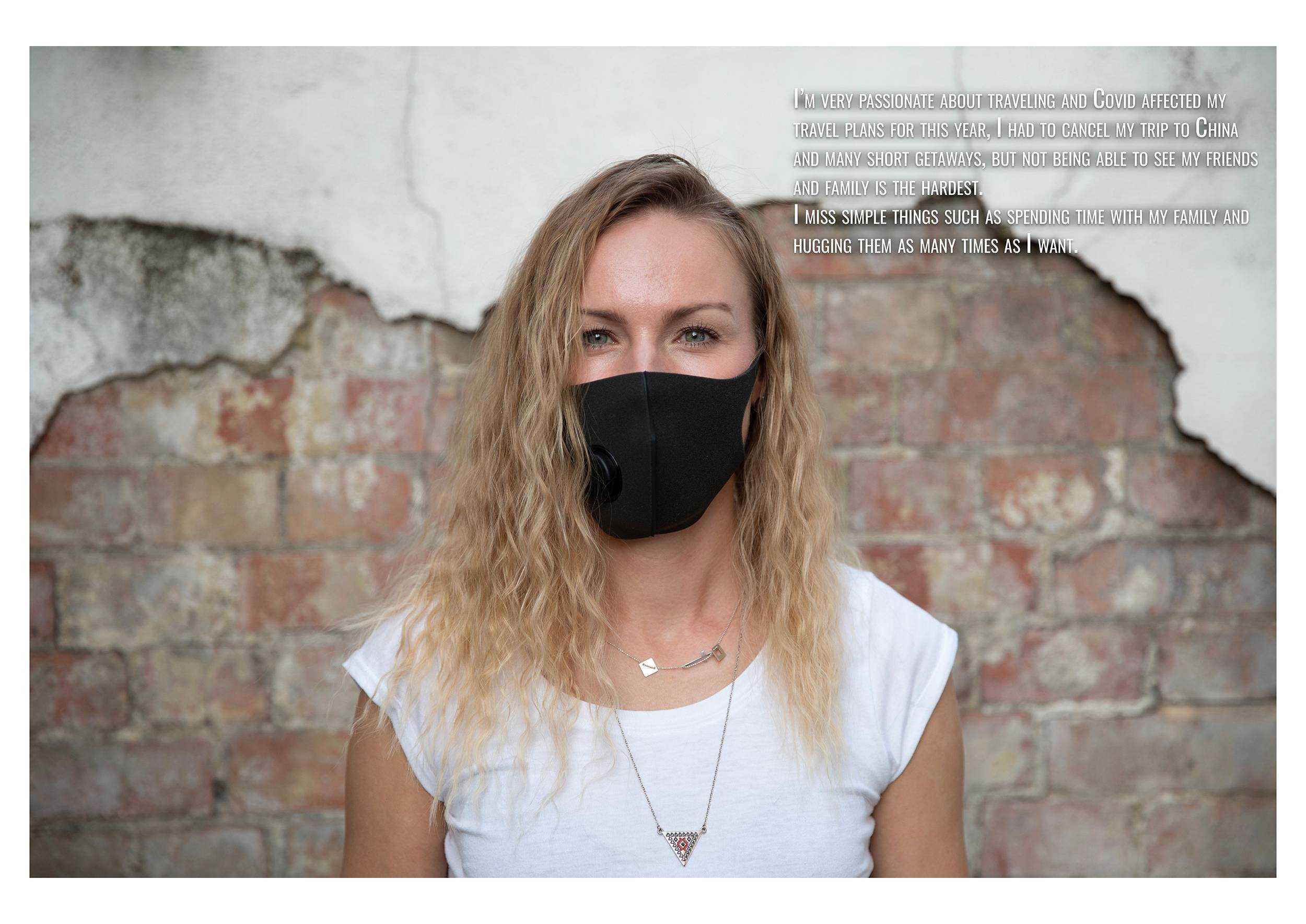 Headshot of a woman wearing a face mask standing in front of a wall with partial exposed brick. A block of text appears in the top-right corner.