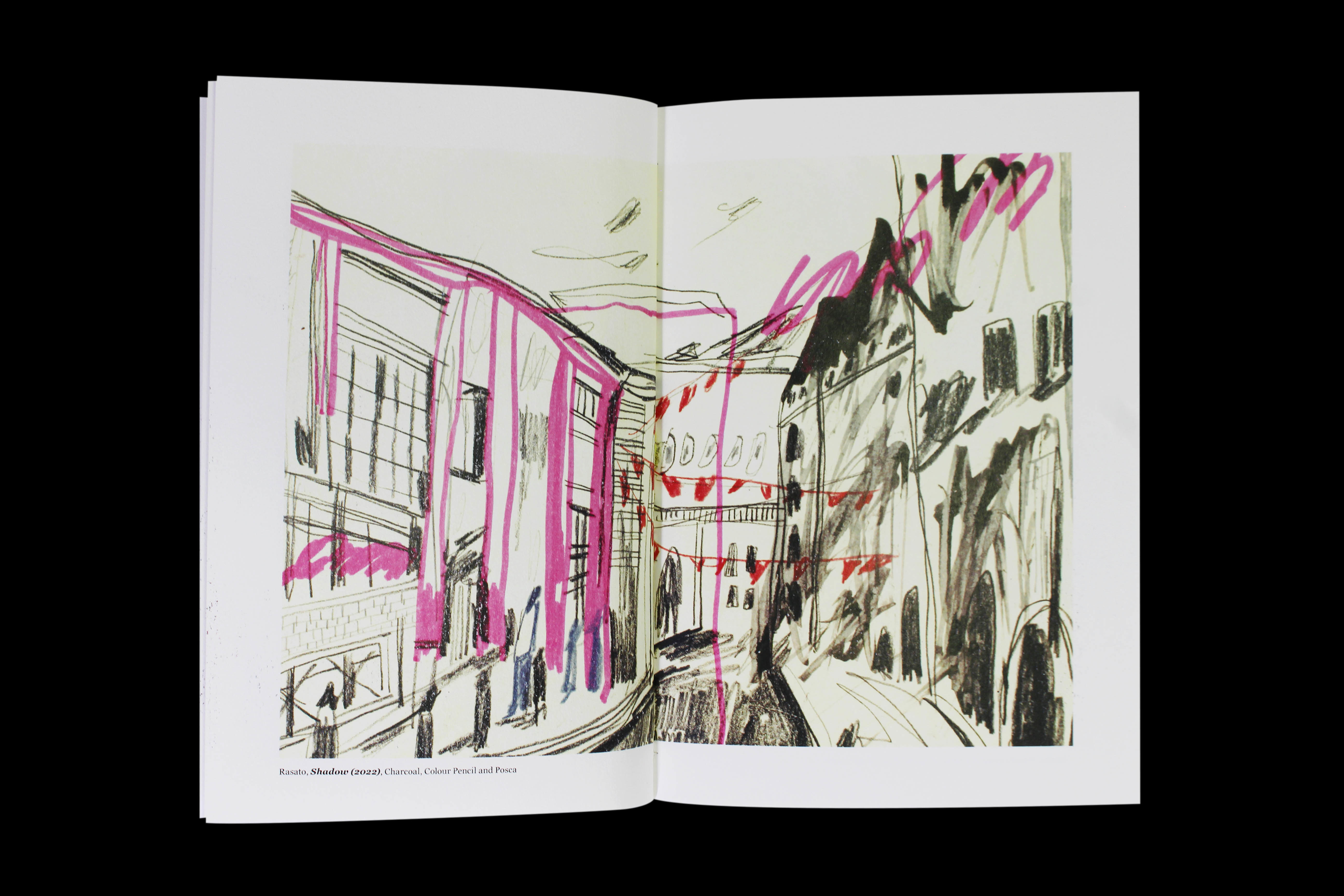 Double-page spread of a book showing a charcoal and colour pencil sketch of a high street with buildings either side and lights hanging between.