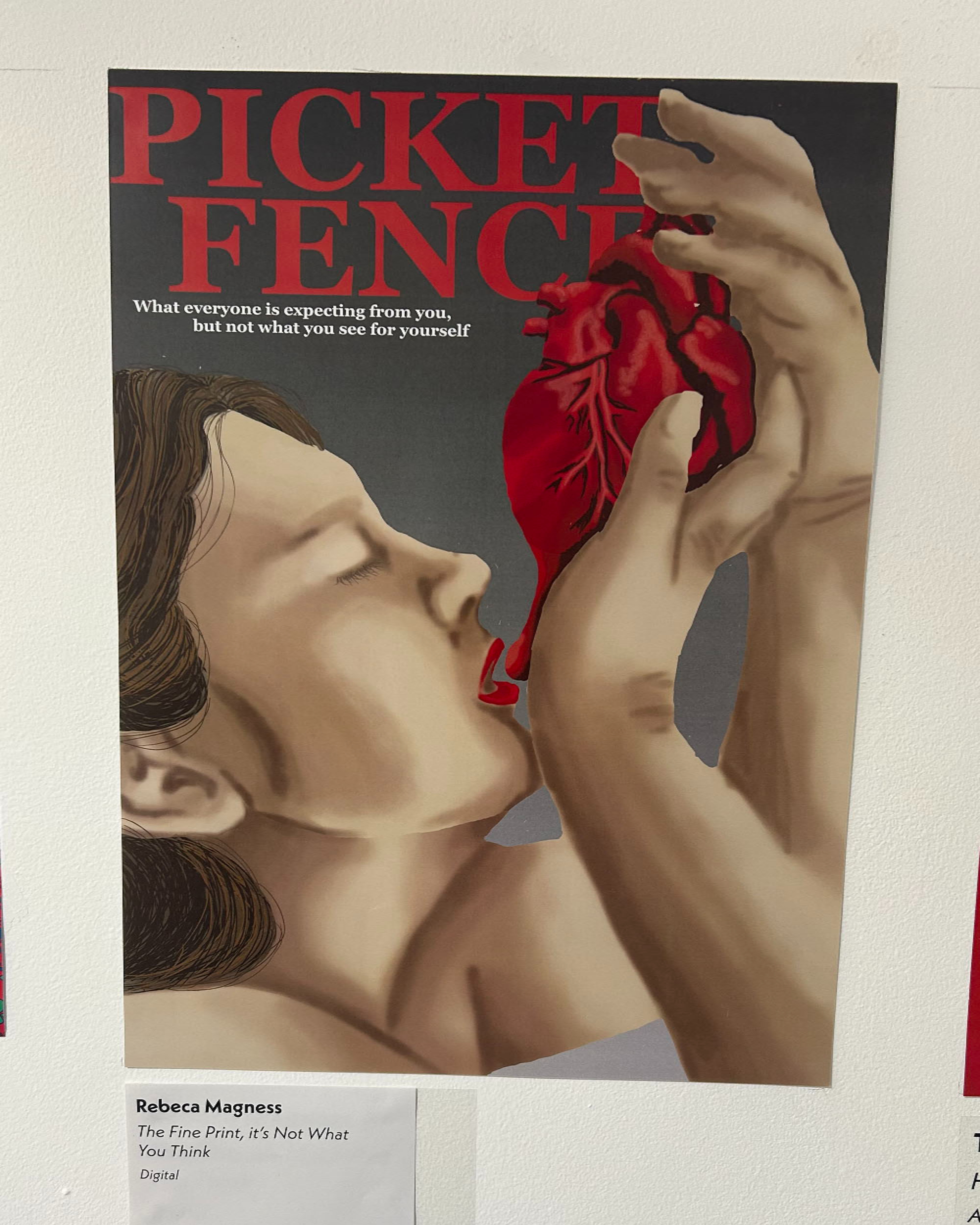 Magazine cover with red "PICKET FENCE" title. Person with brown hair holds red anatomical heart above open mouth. Black background.