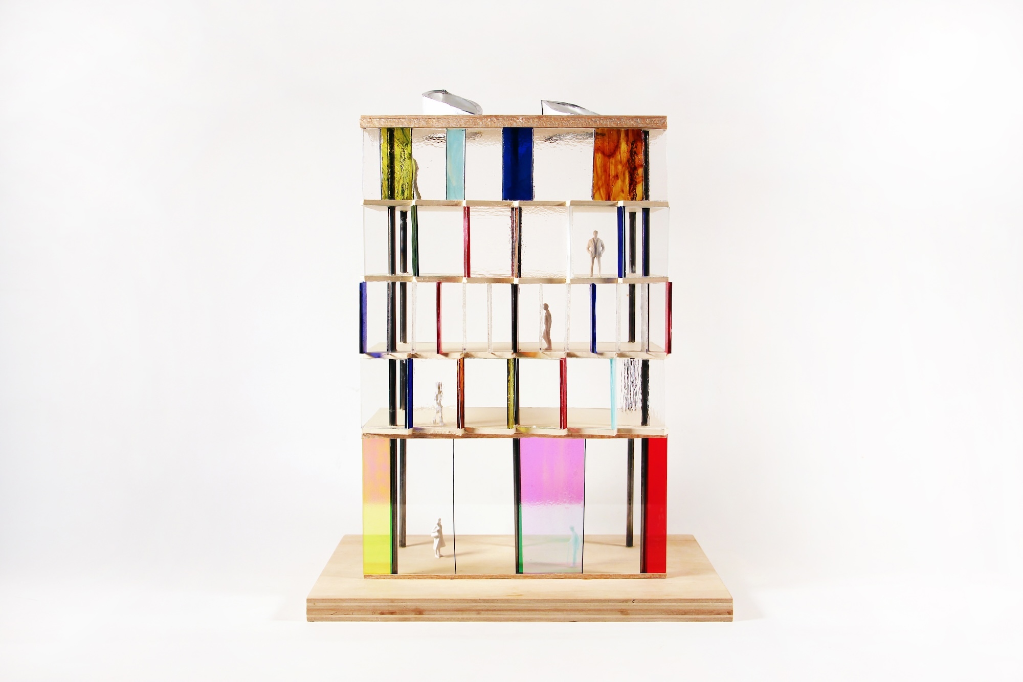 Architectural model of a multi-storey building with different coloured glass panels on each floor.