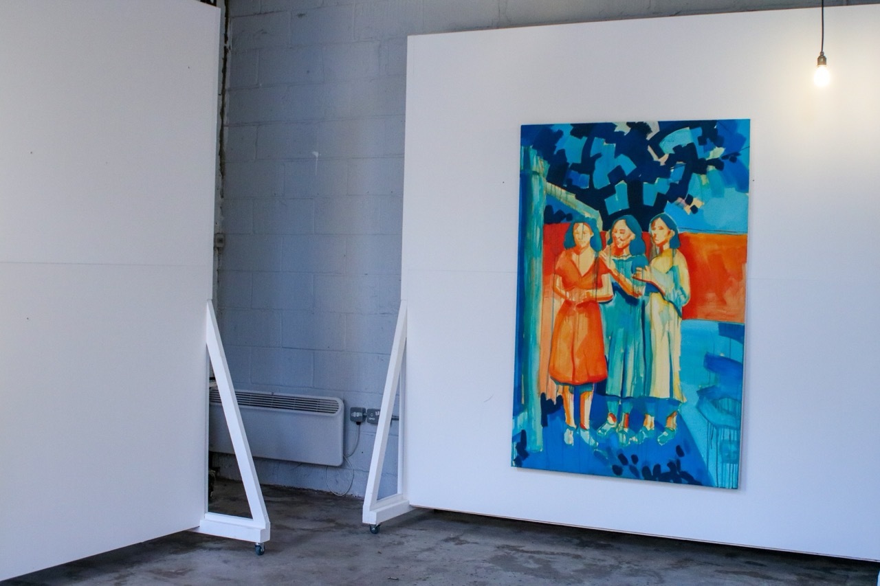 Gallery showcasing a Liz Walker painting, colourful, white walls, lightbulb.