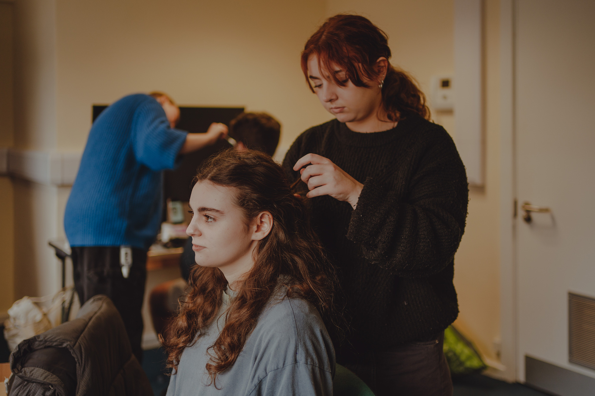 BTS shot of 'Ring Eclipse' showing an actress' hair being done.