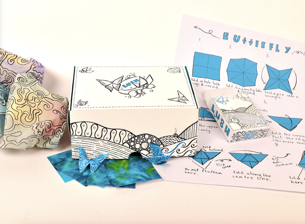 Packaging box design for a Lush product with some of its contents on display, including instructions to make an origami butterfly.