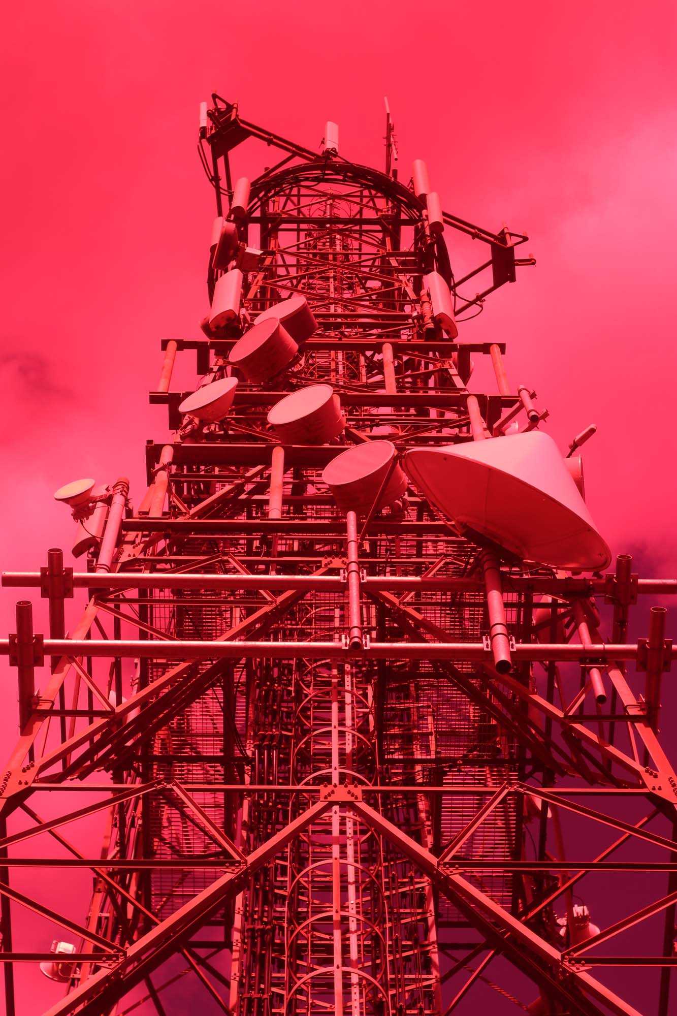 red photo scaffolding and satellite dish tower