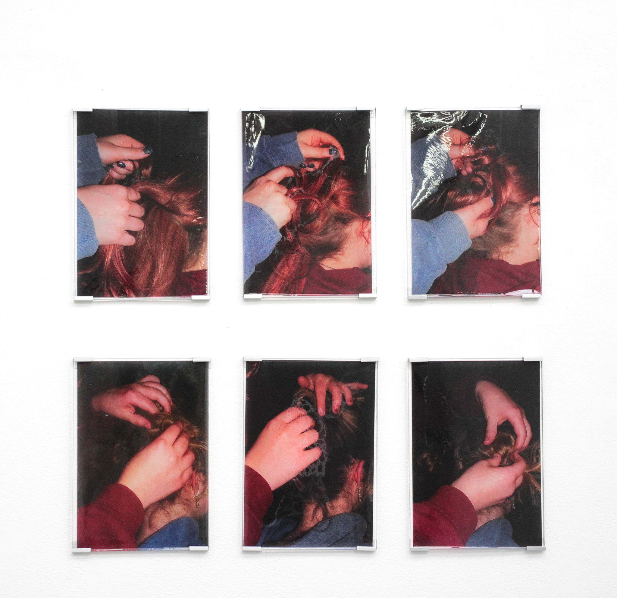 Six images of two girls, one wearing blue the other wearing red, playing with each other’s hair. Top row is blue jumper girl doing reds hair and the bottom is red doing blues. The attempt a mixture of different ties and appear to find comfort in each other company.