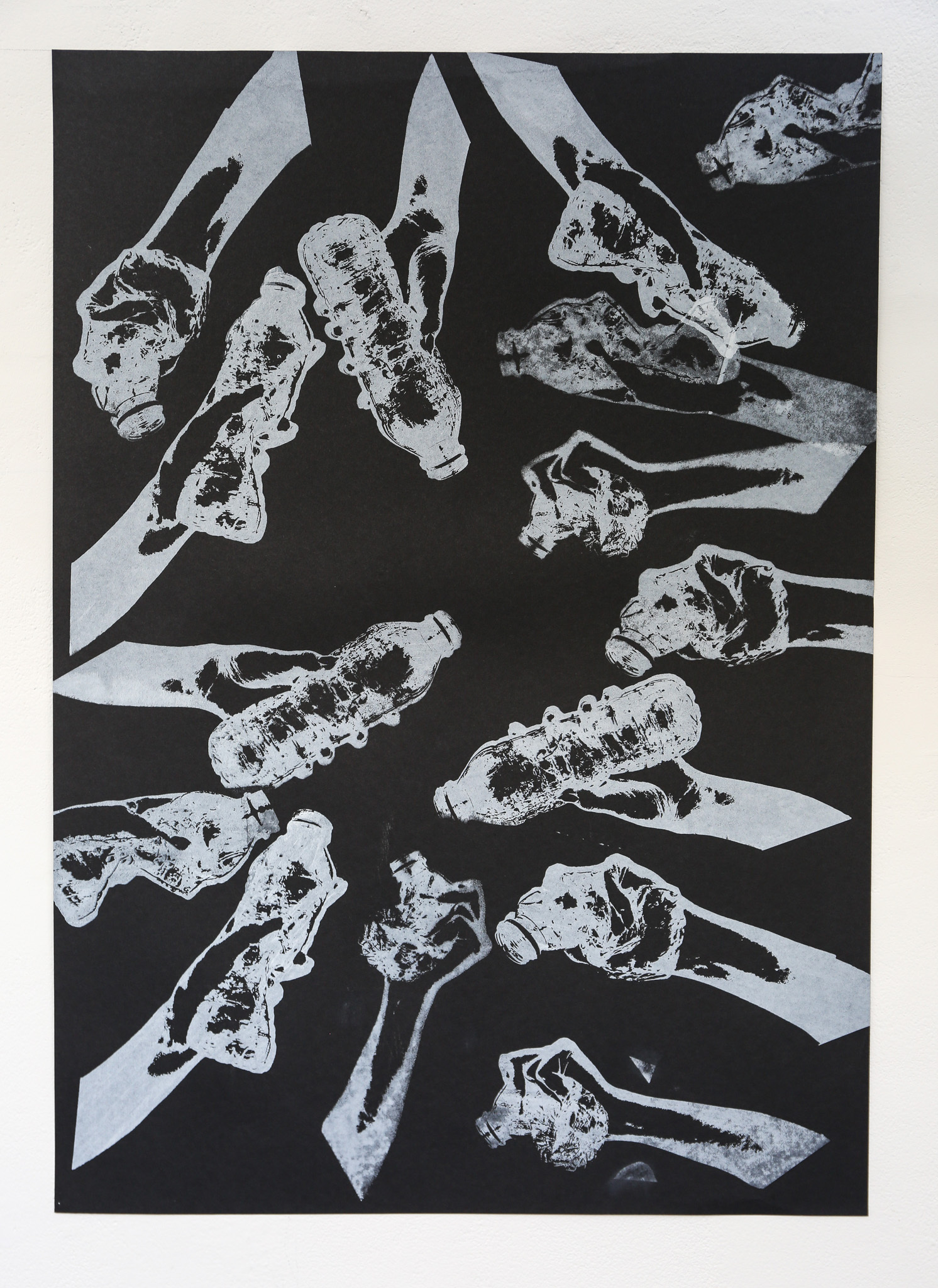 Black and white print showing abstract white shapes with mottled grey textures scattered across dark background in geometric arrangement.