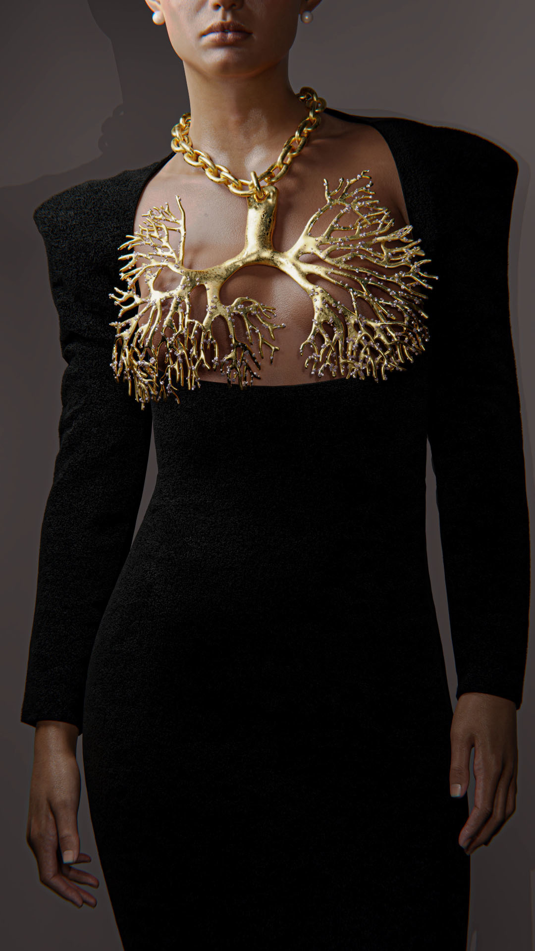 A model wearing a black gown and a large gold chain with a pendant inspired by a pair of lungs.