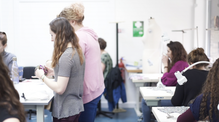 Several people working in a costume studio.