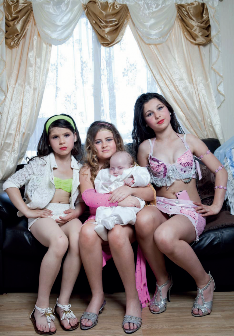 Children holding a-baby on a sofa