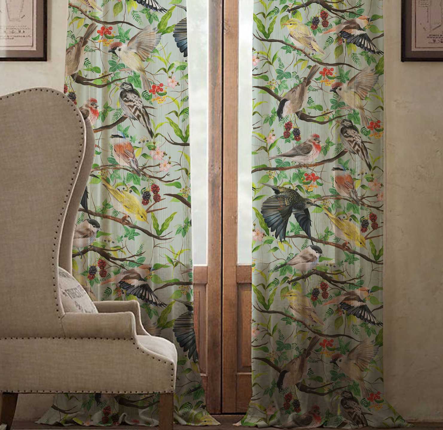 A pair of curtains showing different species of birds perching and flying around tree branches. An armchair stands on the left.