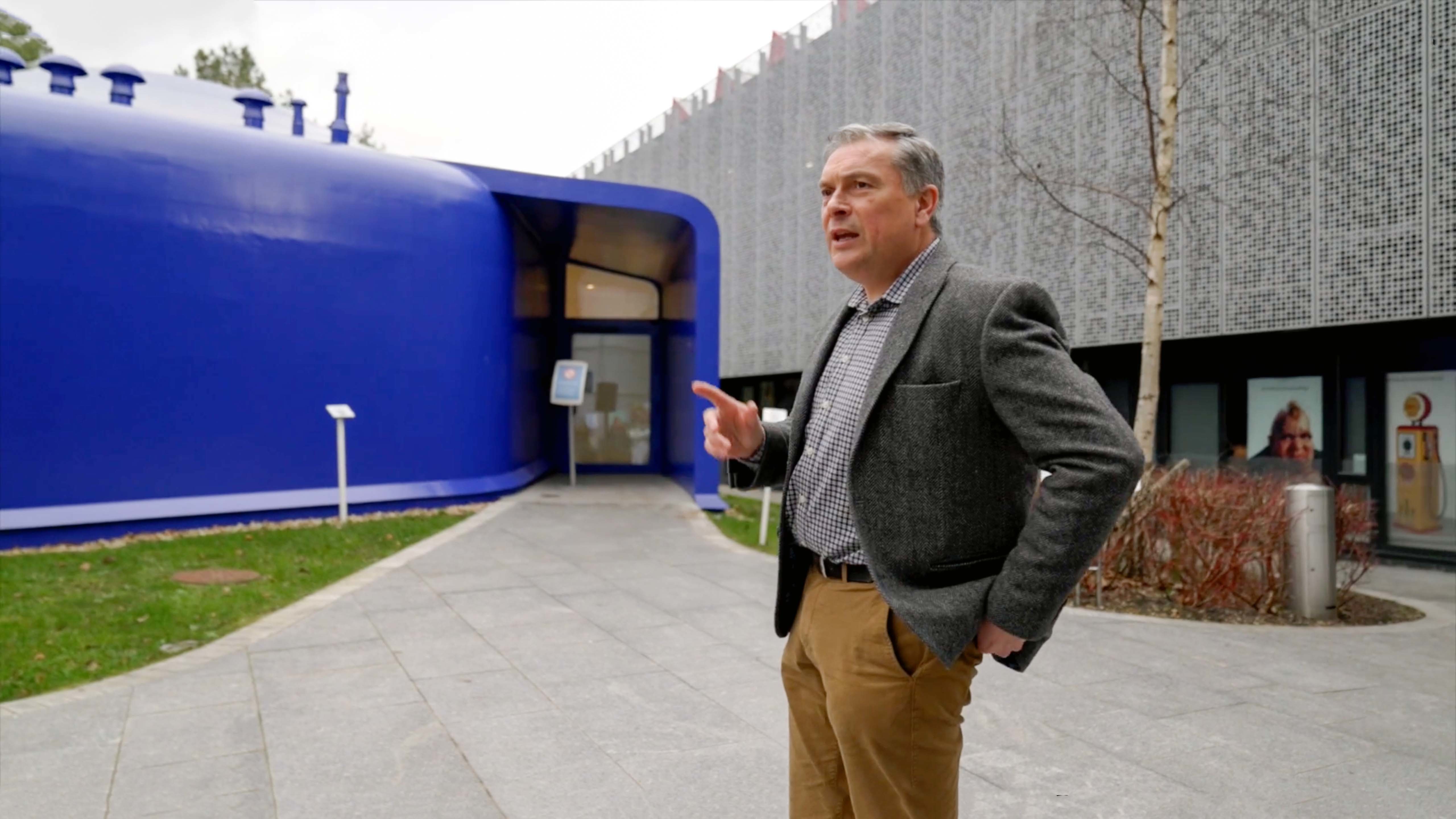 K Chambers standing on the footpath outside the AUB Drawing Studio building.