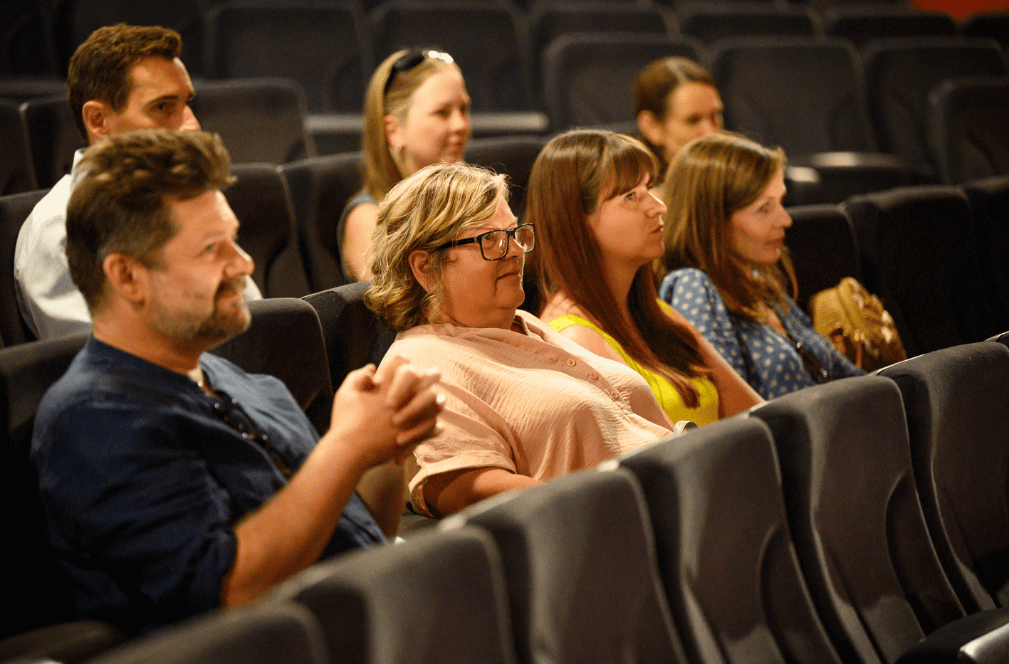 Audience members smiling during the boys performance at Palace Court Theatre