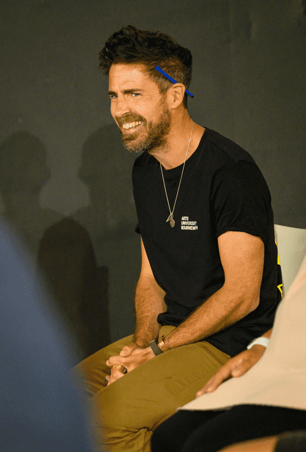 Workshop leader Dan Boyden smiling during group activity on stage at Palace Court Theatre