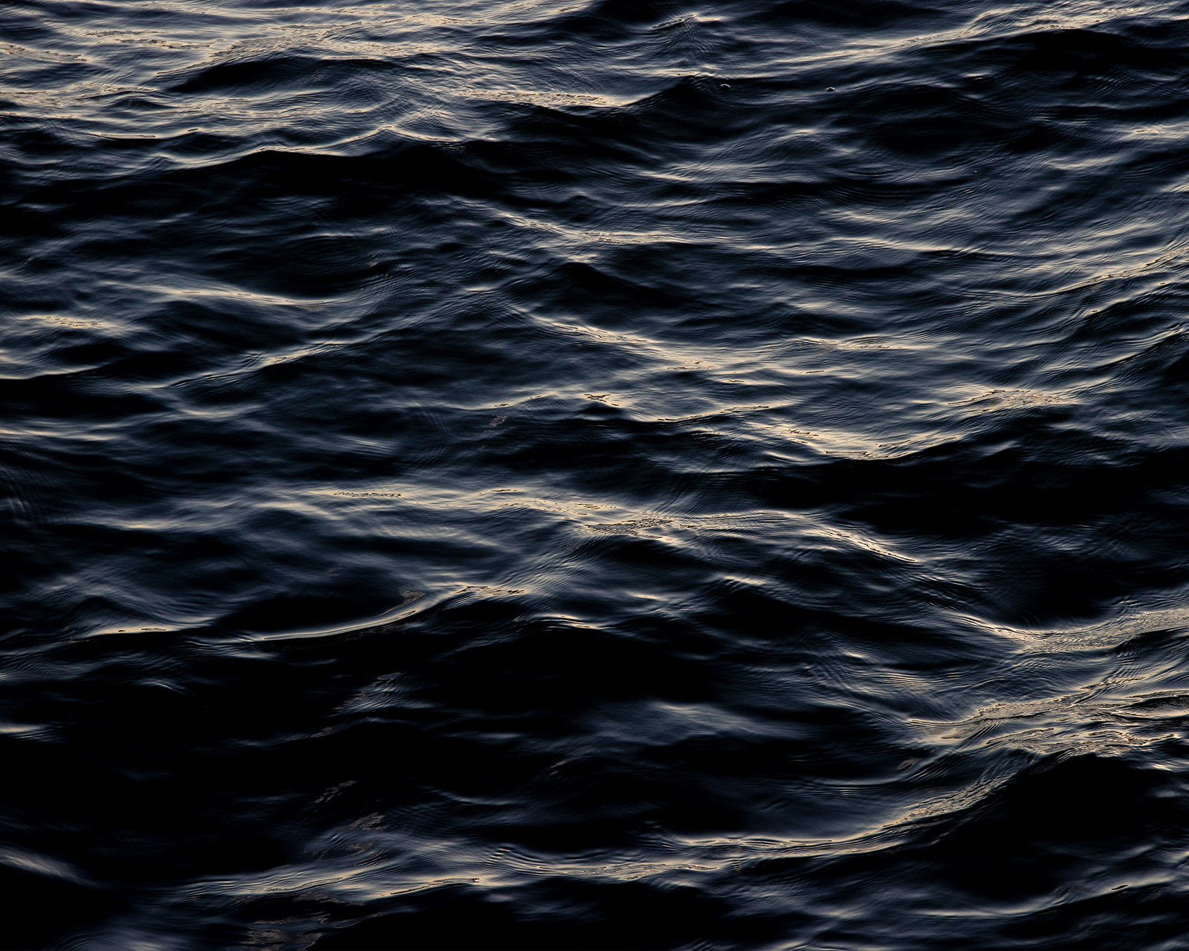 Close up in on the waves in the sea in the dark