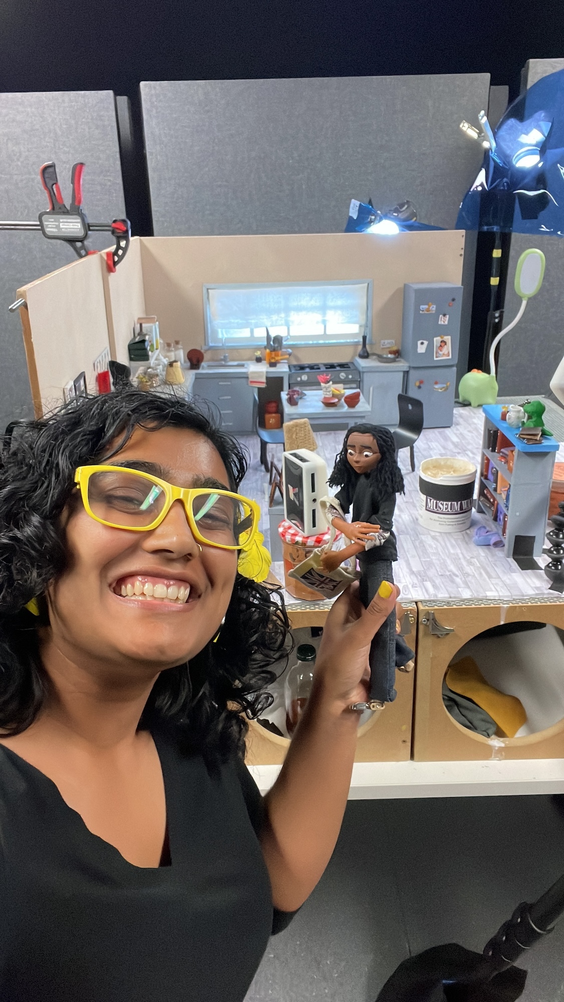 K Roy-Meighoo posing and taking a selfie with the set for her animated final film behind her.