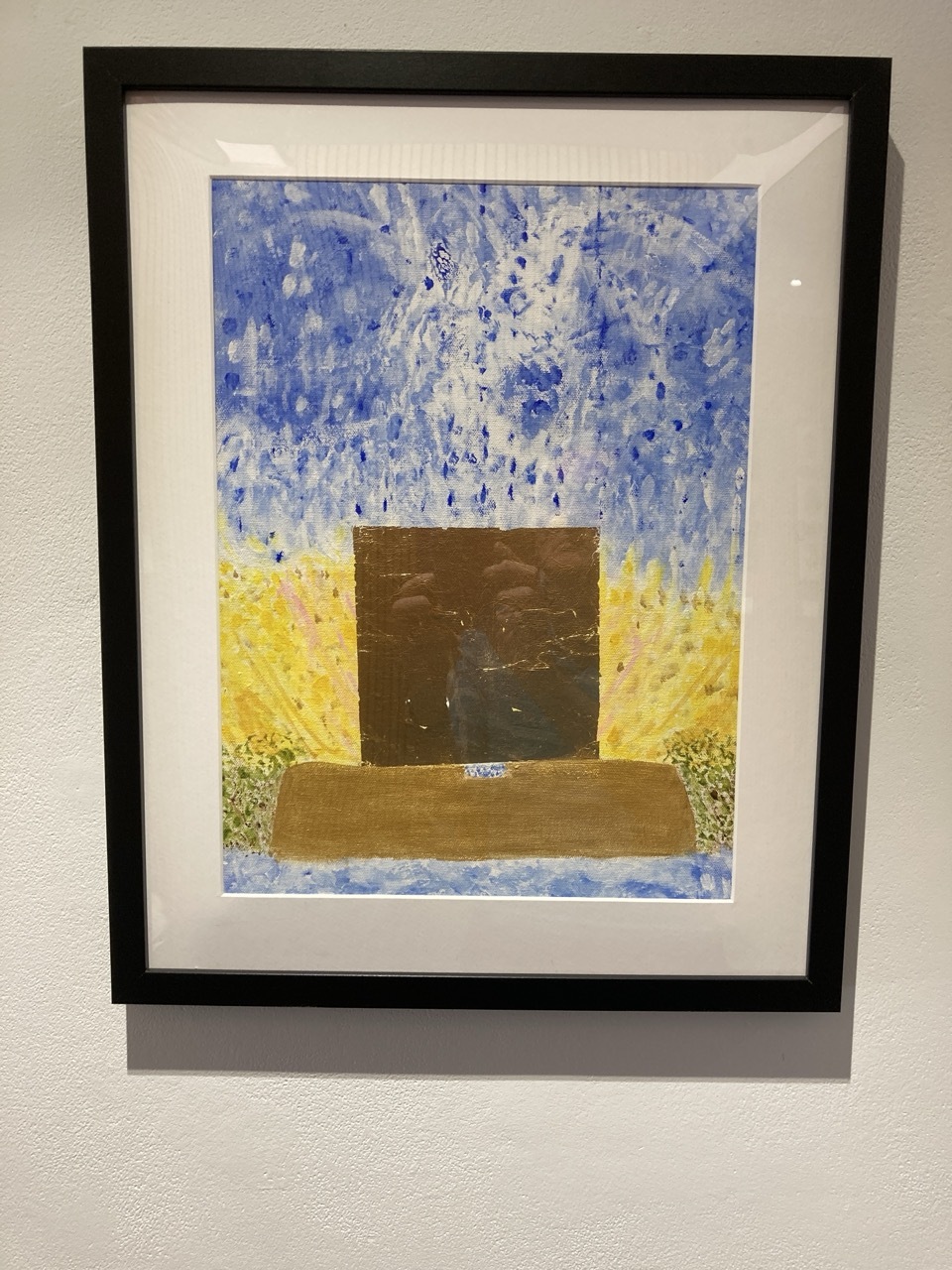 Framed abstract painting with blue speckled upper portion, yellow sides, dark brown square centre, and olive horizontal rectangle below.