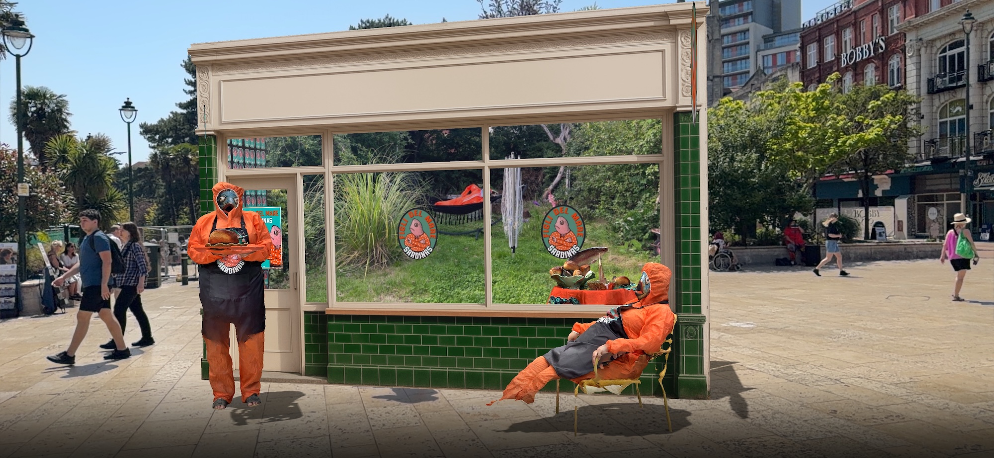 Two people in orange protective suits stand and sit beside a small green kiosk with large windows, in a city square with pedestrians and trees in the background.