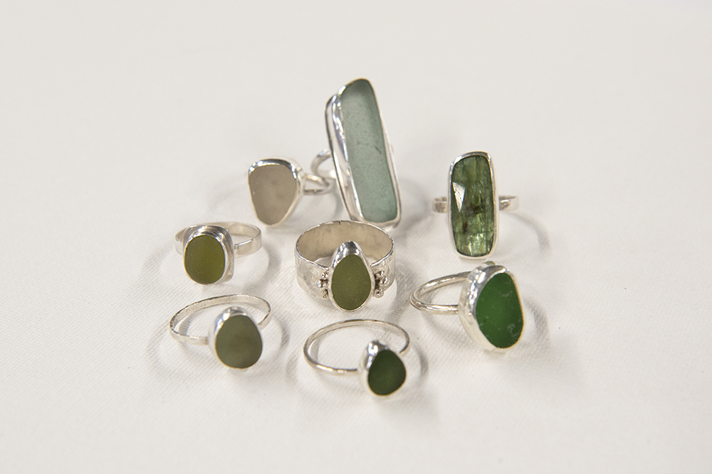 A selection of rings with various-sized green and yellow gemstones.