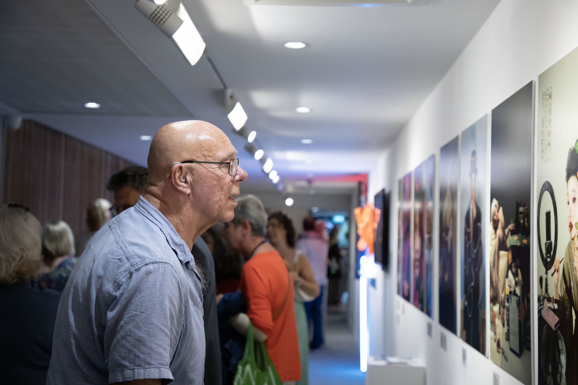 A person examining artworks at TheGallery during the 2023 Snapshot shows.