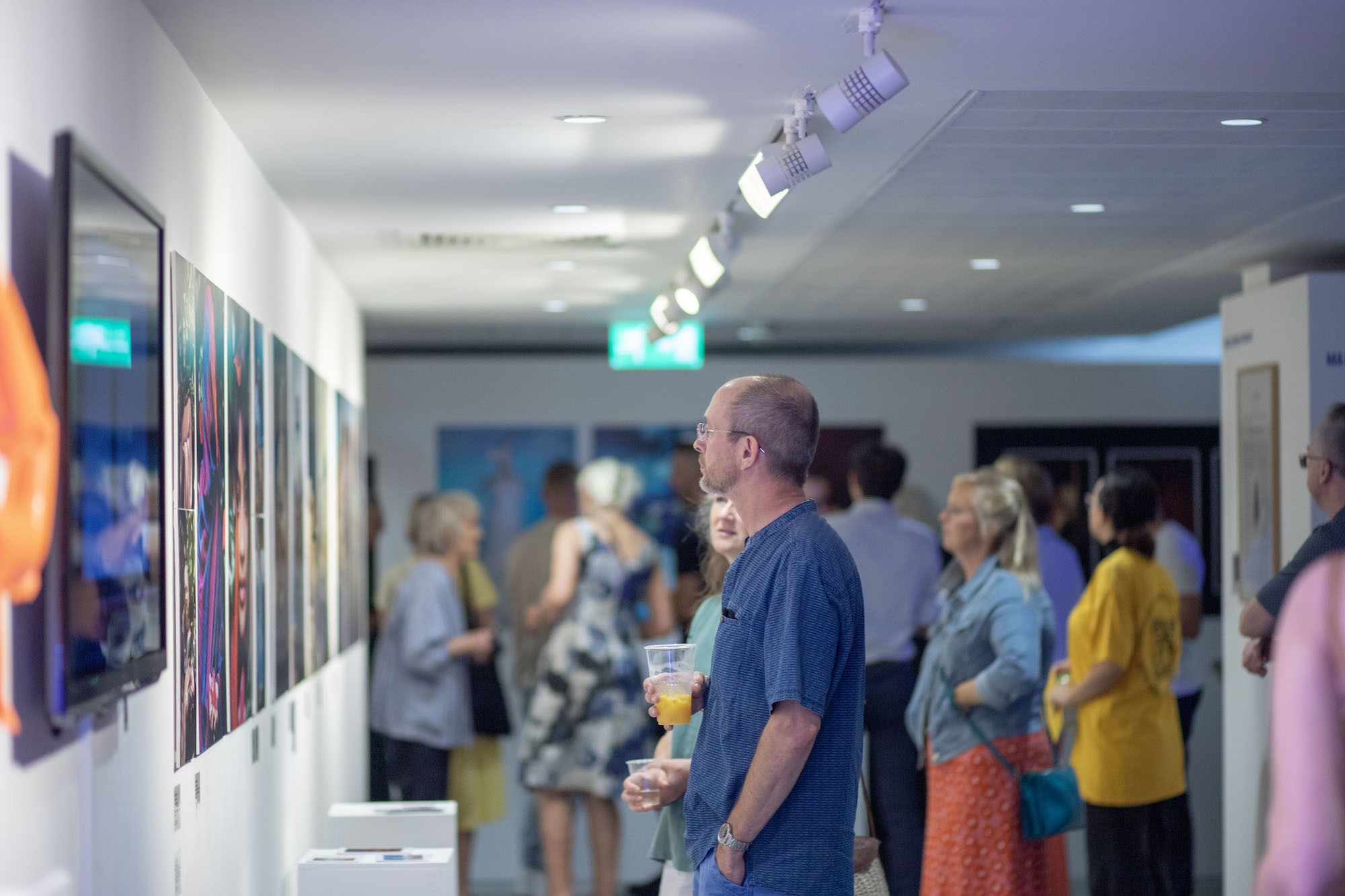 A group of people in a space at TheGallery looking at artworks at the 2023 Snapshot shows.
