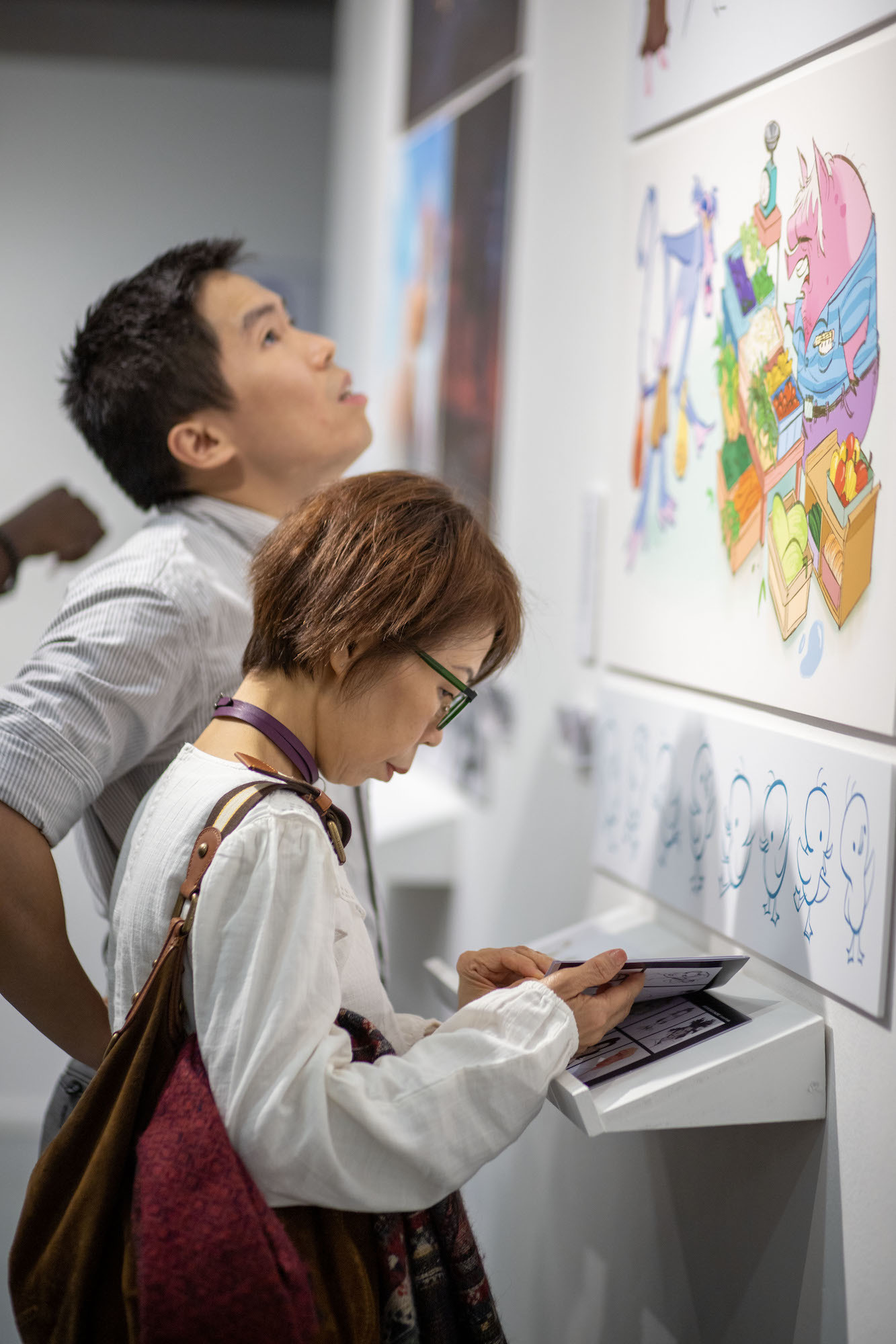 Two visitors examining exhibits at TheGallery during the 2023 Snapshot shows.