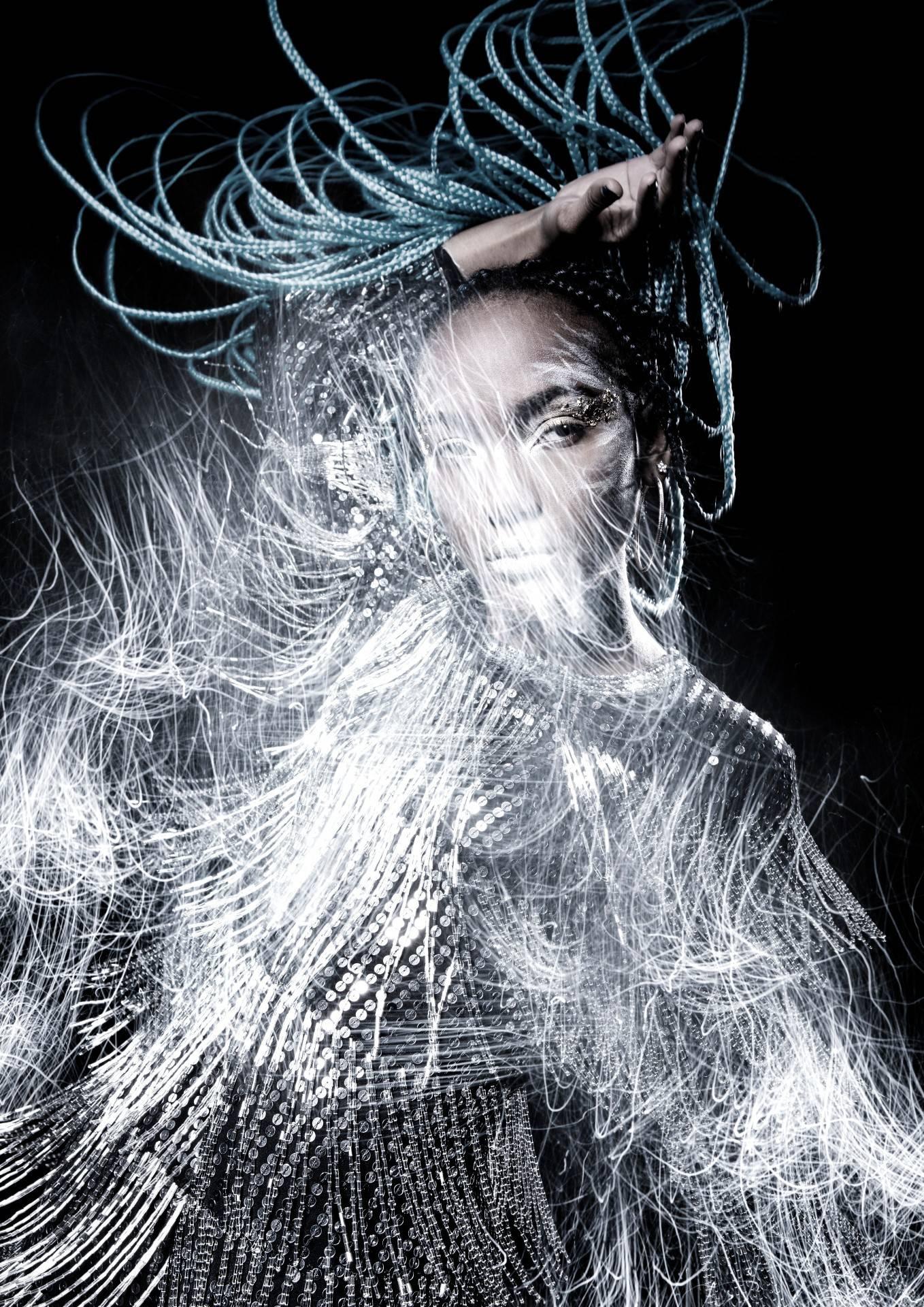 A model in a sequinned costume poses for a photo.
