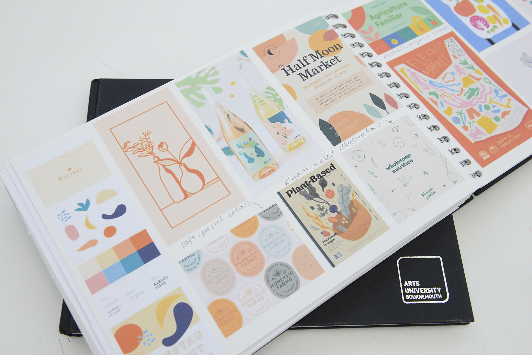 An open portfolio book showing a series of designs for a brand called 'The Half Moon Market'.