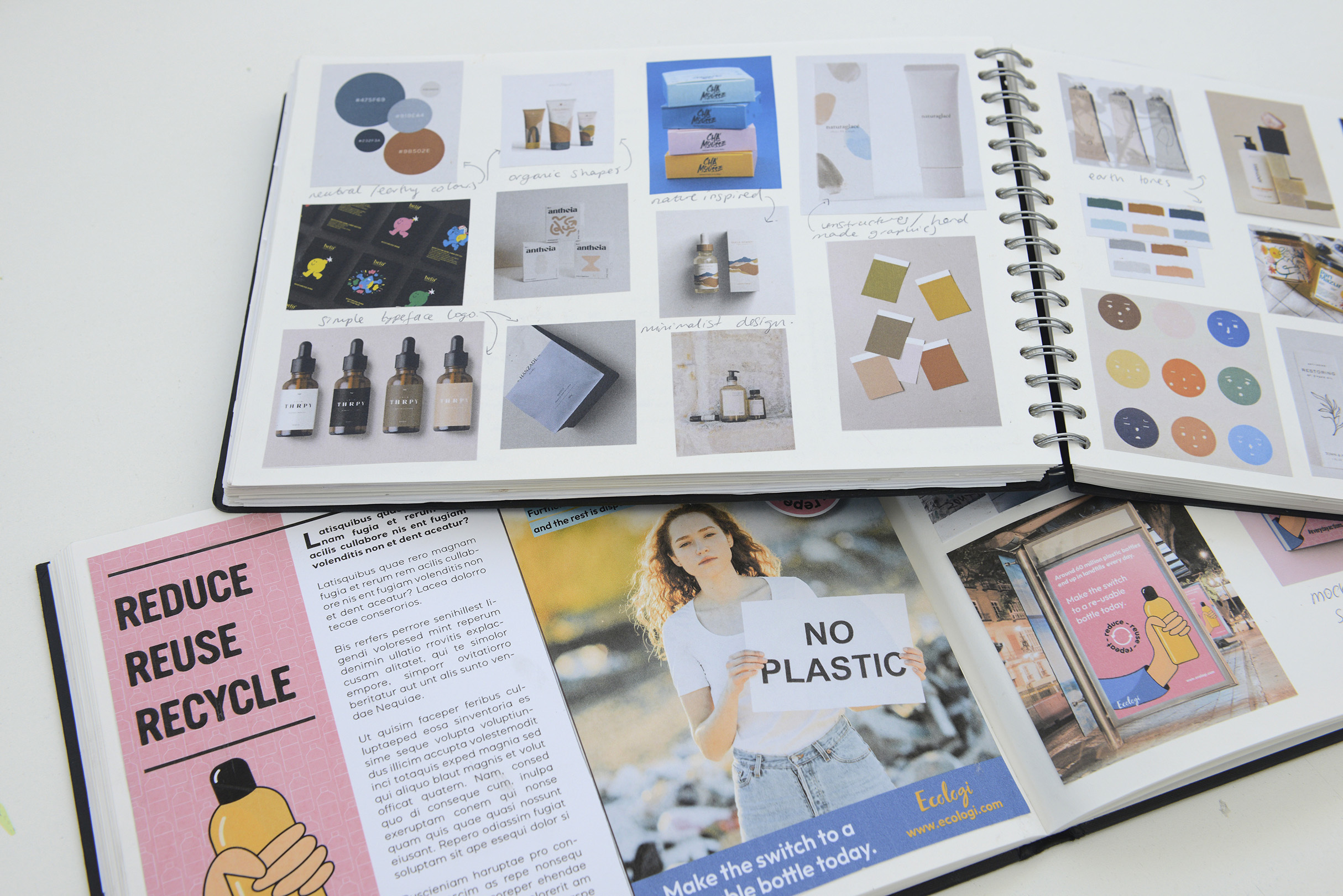 Double page spreads of two books, one lying on top of the other, both containing a series of large images and blocks of text.