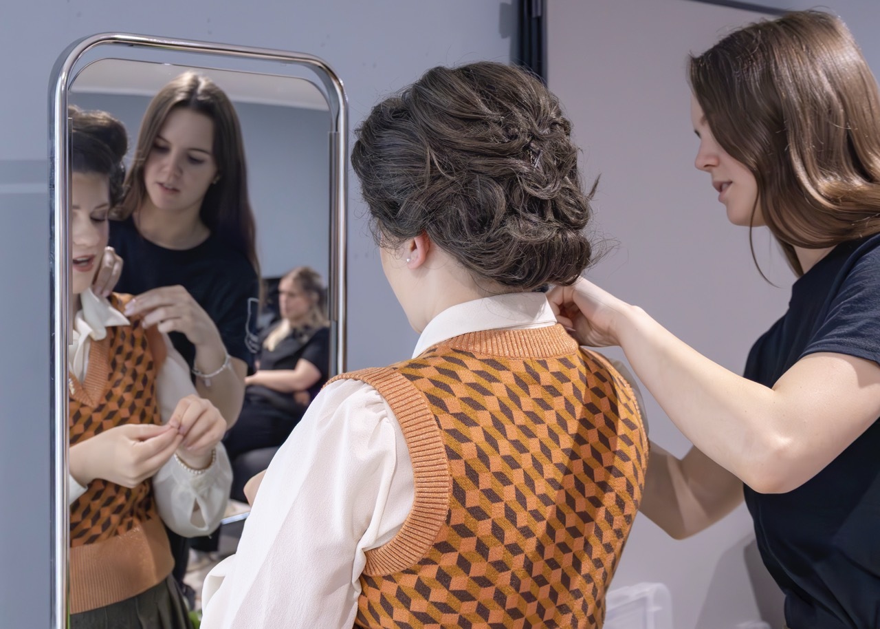 I am adjusting the collar of one of the actors Jade. I am also doing my final costume checks of everyone before they enter the stage.