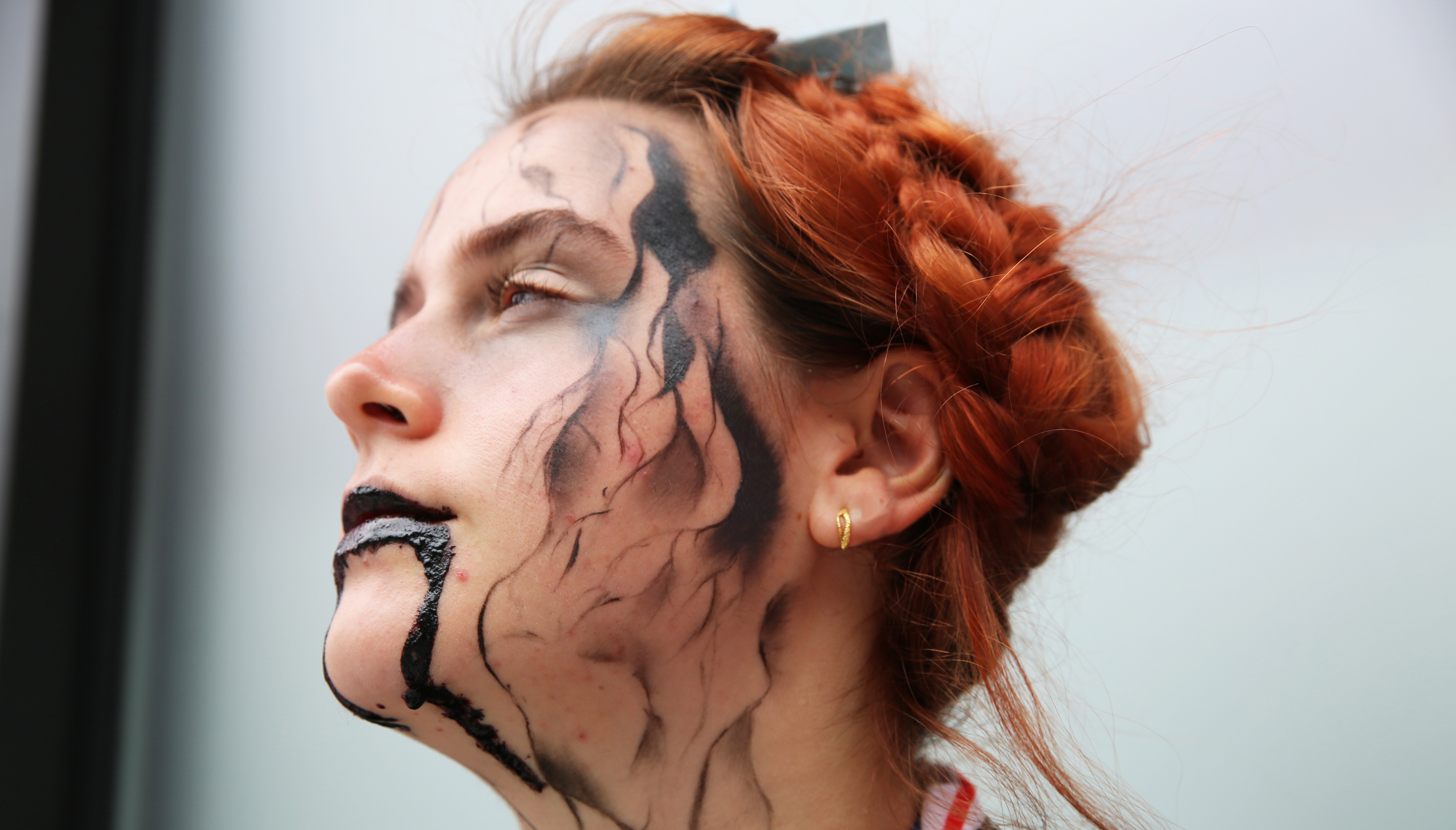 A student has black paint dripping down their face