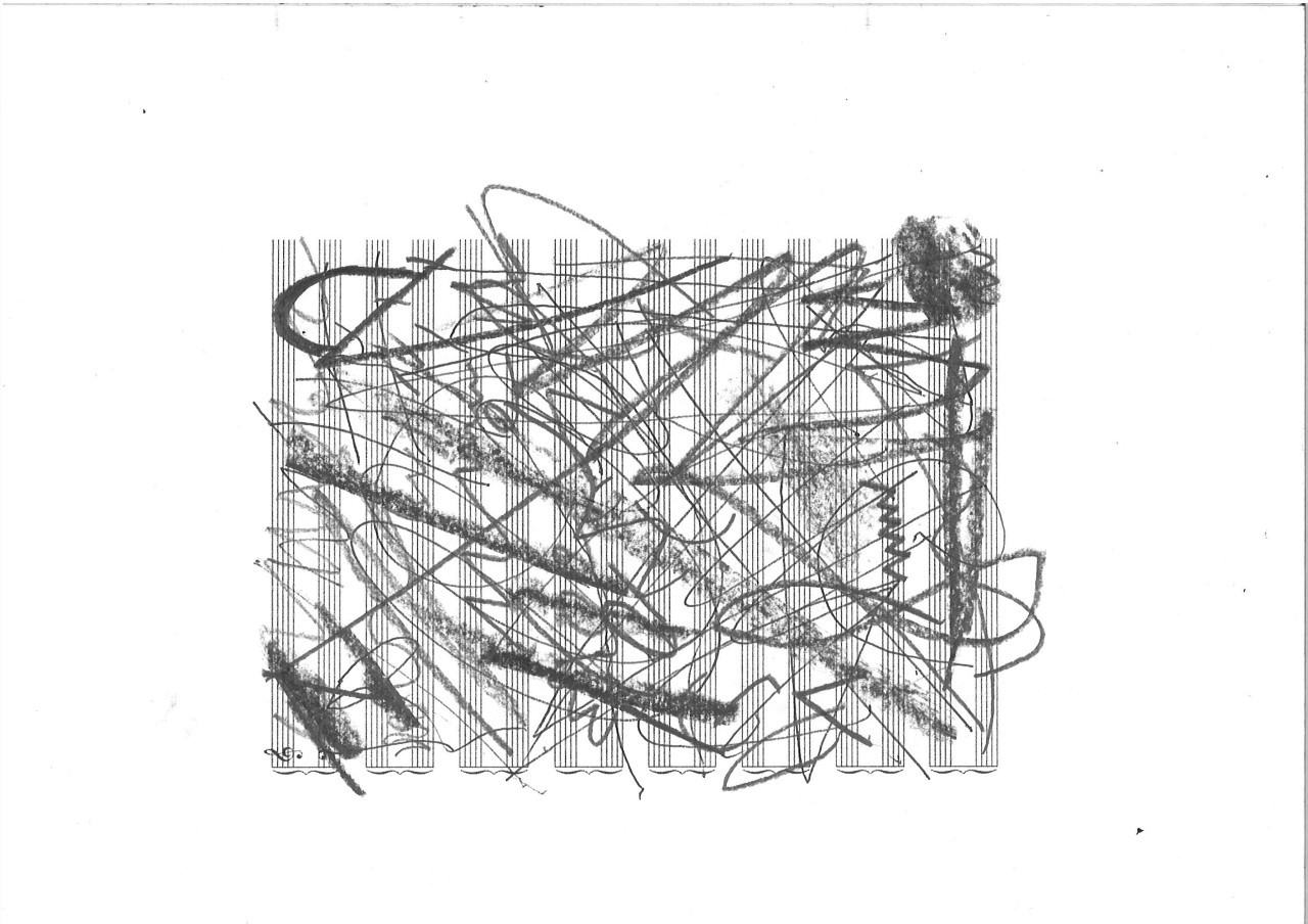 A piece of sheet music paper rotated and covered in charcoal scribbles