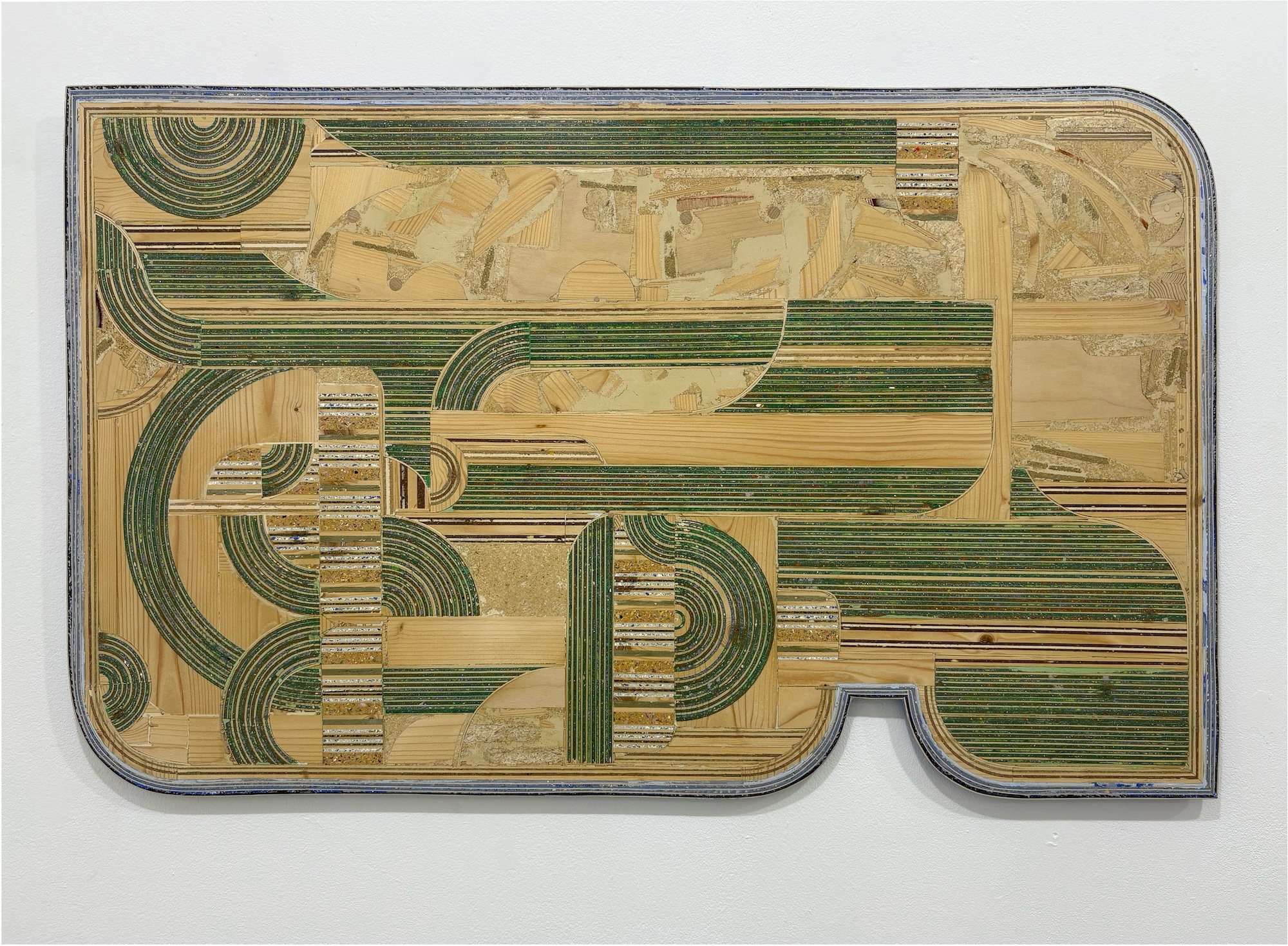Circuit board with green curved tracks and rectangular patterns on beige background, silver metal edges