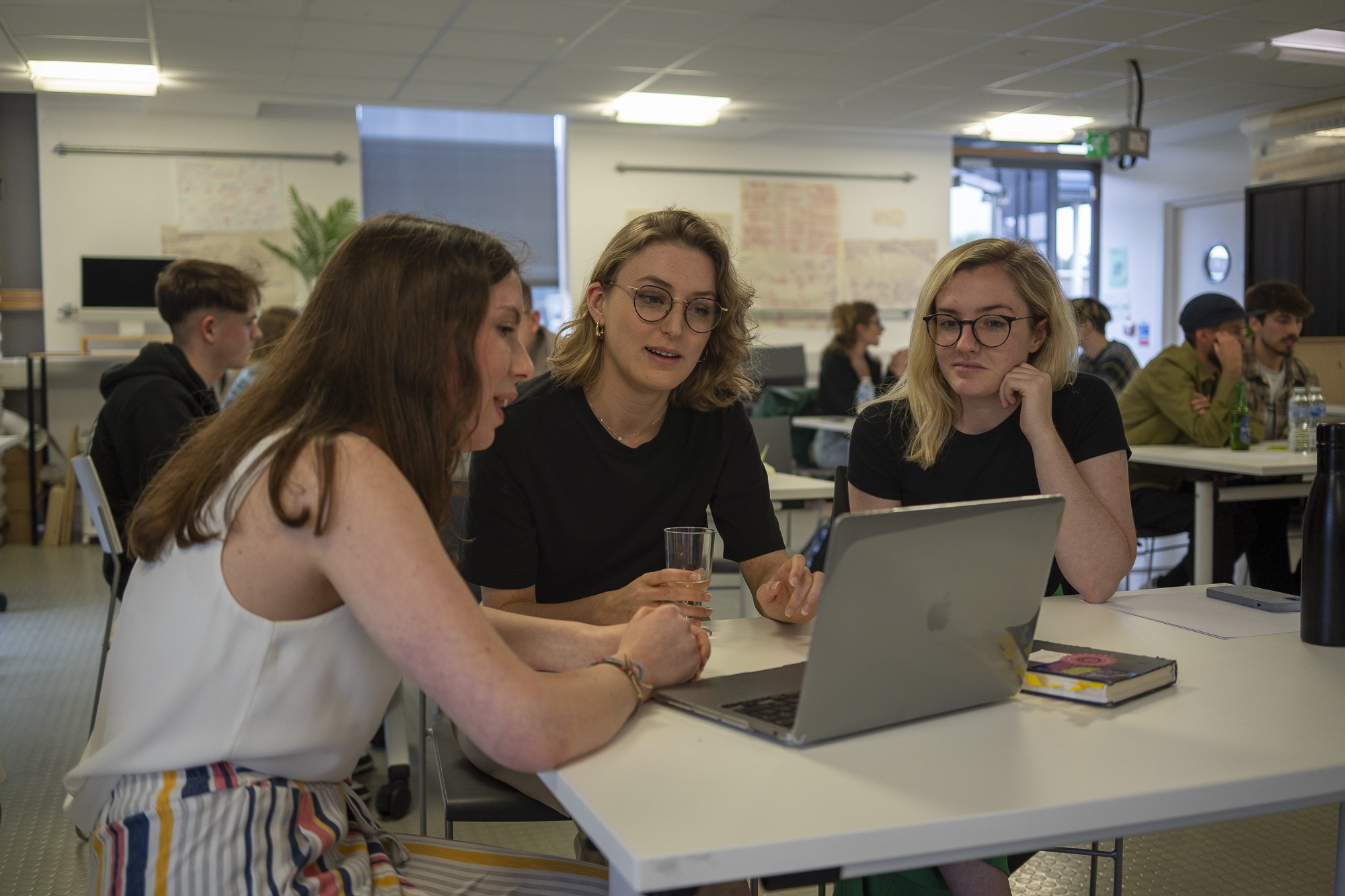 BA (Hons) Graphic Design alumni L Drake and I Fiske conducting a portfolio review with a BA (Hons) Graphic Design student at the 2024 Level 5 networking event.