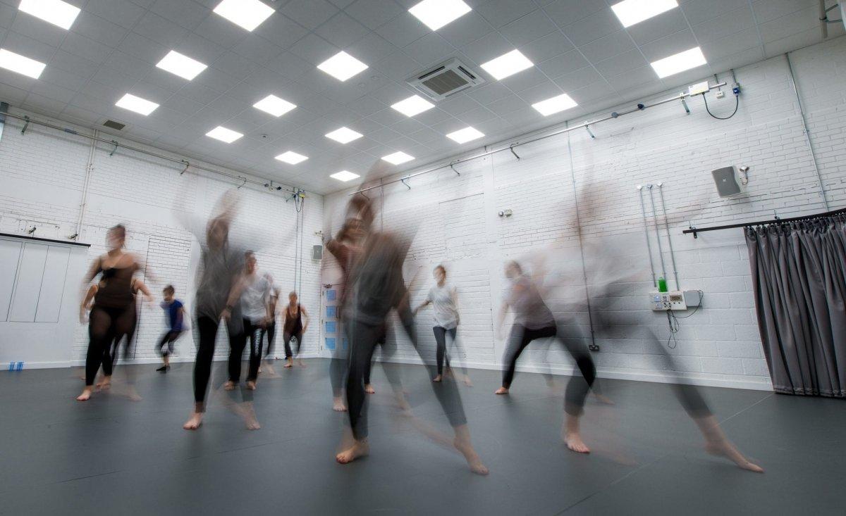 A group of students dancing in a dance studio.