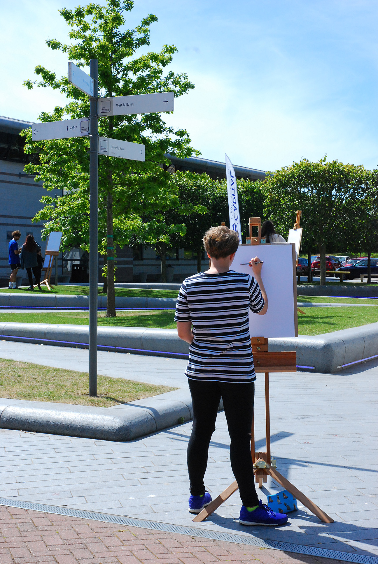 Student drawing on easel