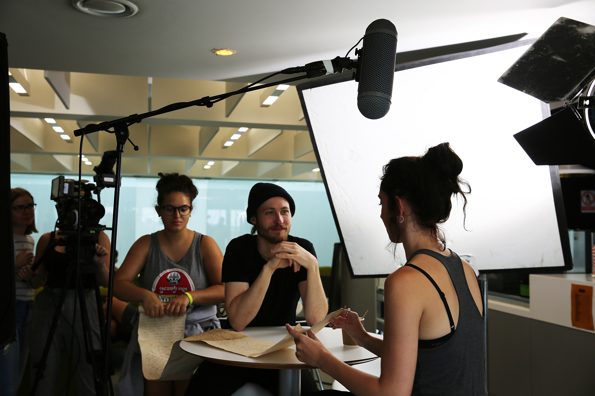 Young students using camera equipment to make a film